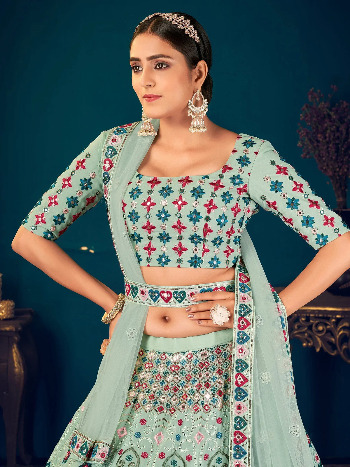 Mint green embroidered lehenga choli with floral motifs and matching dupatta, perfect for Indian ethnic wear.