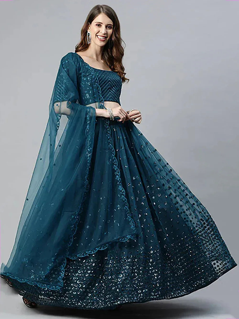 Teal blue designer lehenga choli with sequin embroidery and sheer dupatta, perfect for Indian ethnic occasions