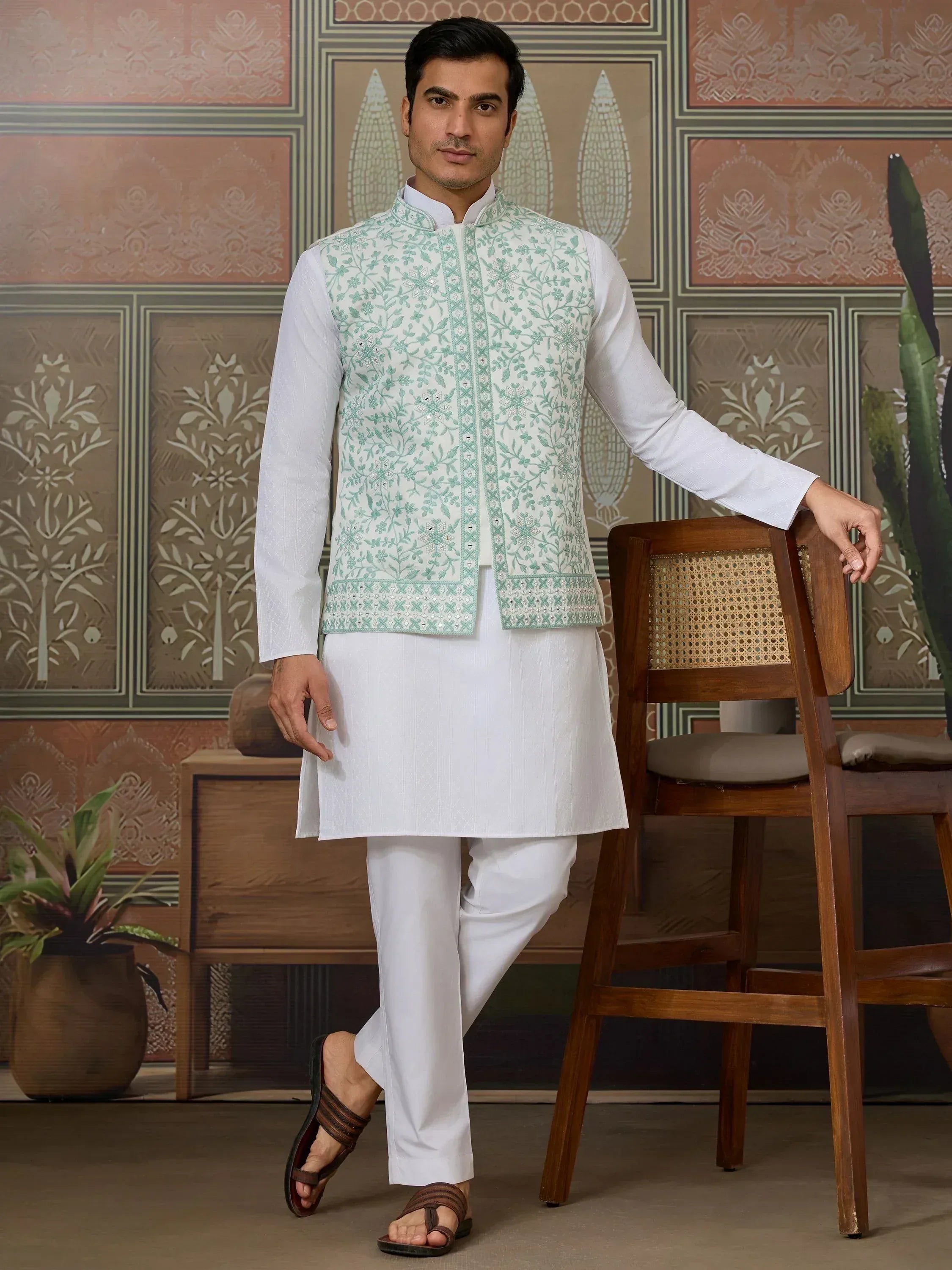 Man in white kurta pajama with mint green embroidered Nehru jacket, ethnic Indian wear