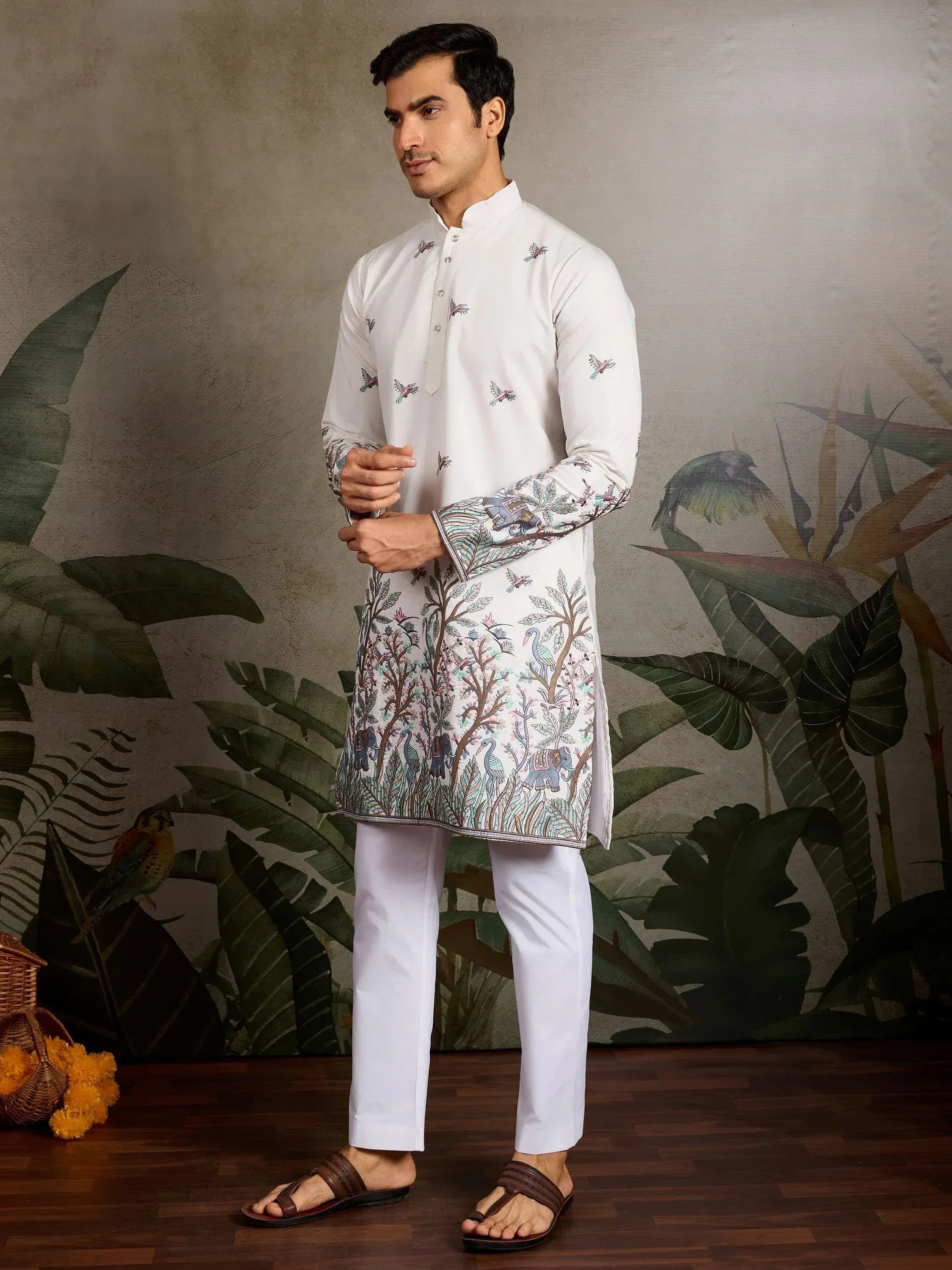 White embroidered kurta set with bird and elephant motifs, paired with churidar pants for men's ethnic wear