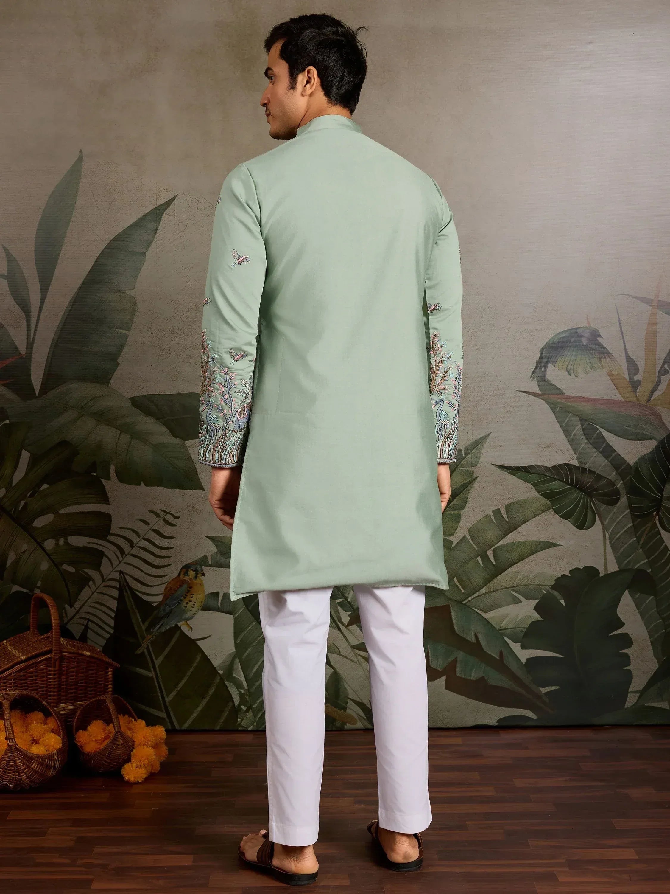 Mint green embroidered kurta with white pants, featuring bird and floral sleeve details, ideal for ethnic occasions.