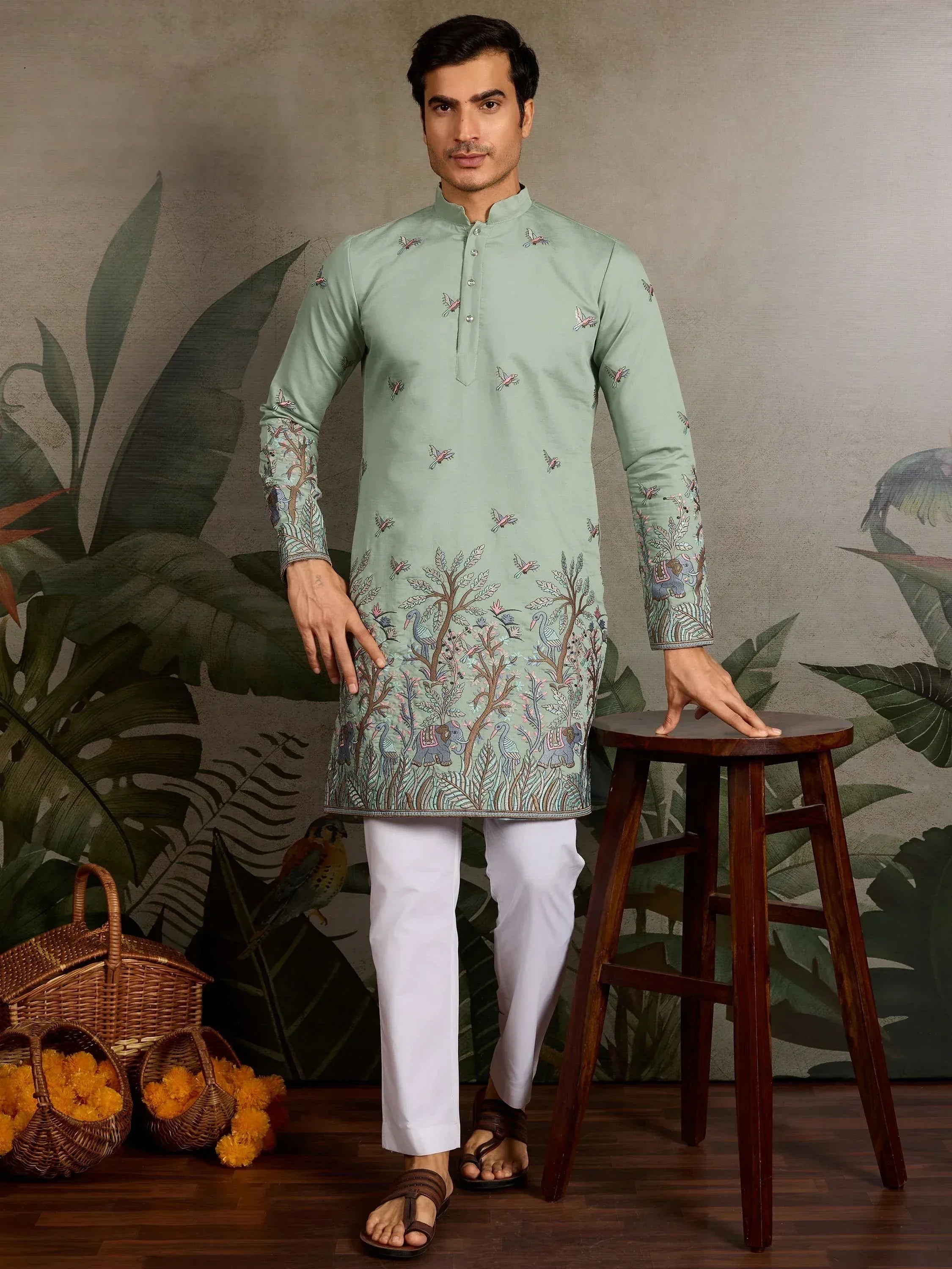 Mint green embroidered kurta with elephant and bird motifs, paired with white pants for ethnic wear.
