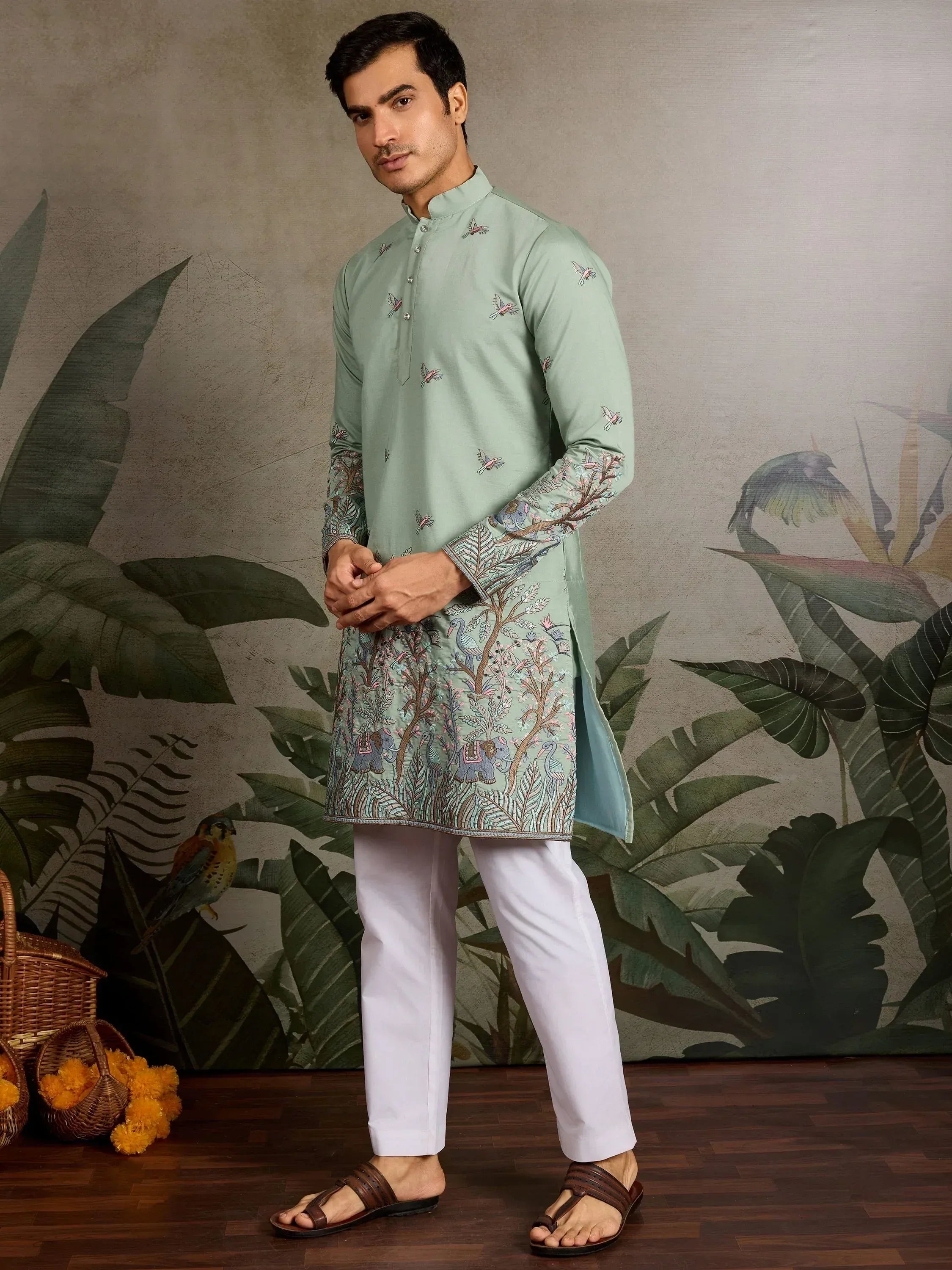 Mint green embroidered kurta with elephant and bird motifs, paired with white pants for ethnic wear