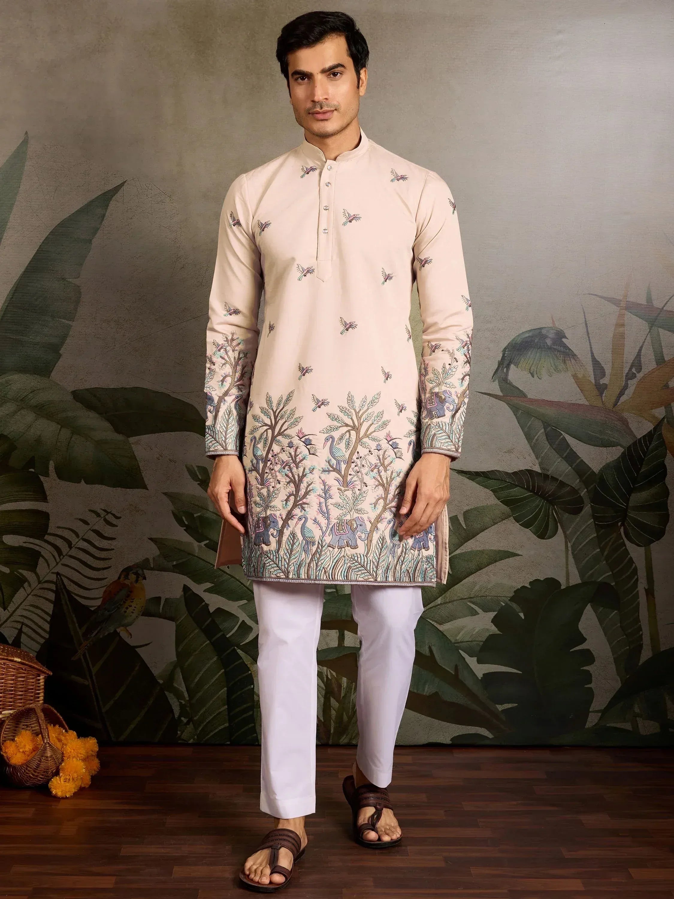 Men's ethnic kurta with bird and elephant print, paired with white pants for festive occasions