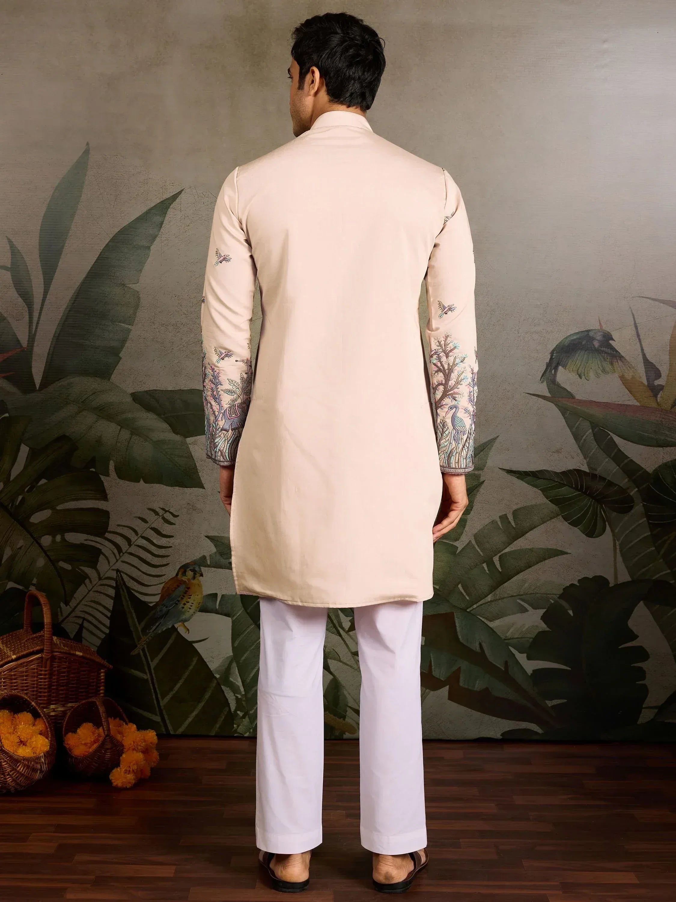 Men's beige kurta with bird and tree embroidery, paired with white pants, for ethnic occasions
