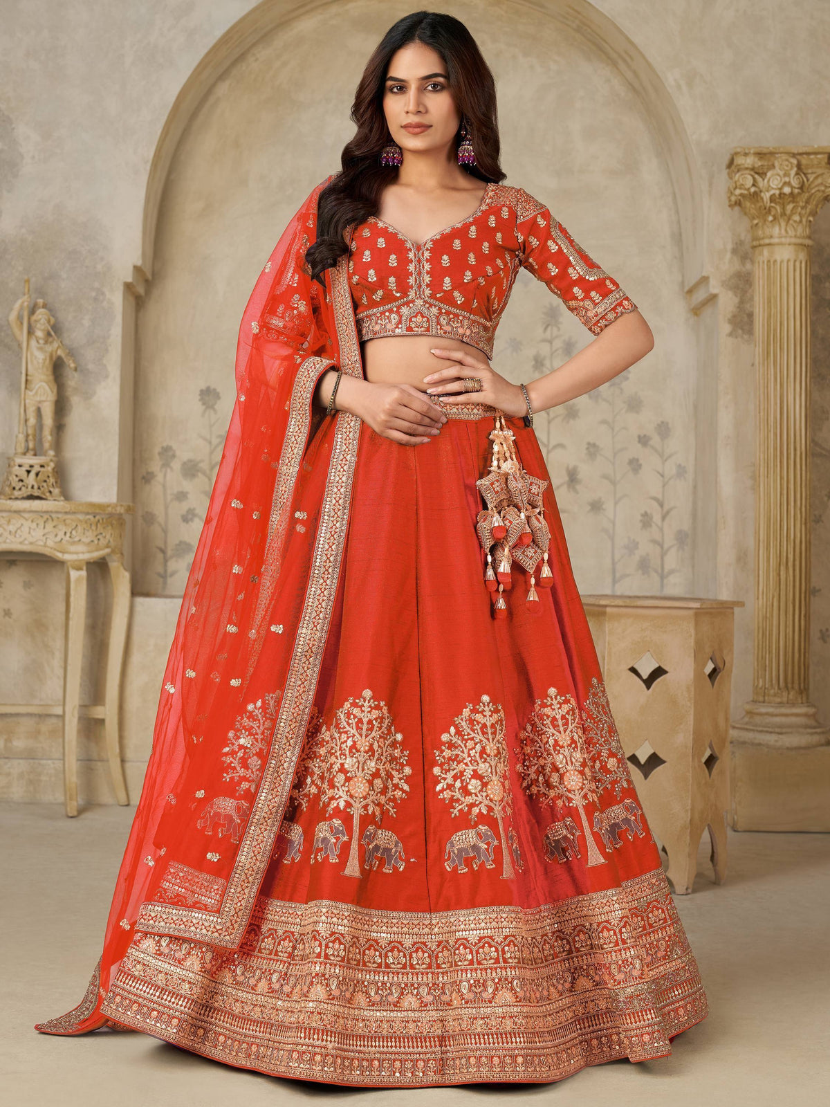 Red embroidered lehenga choli with elephant and tree motifs, perfect for Indian weddings and festive occasions