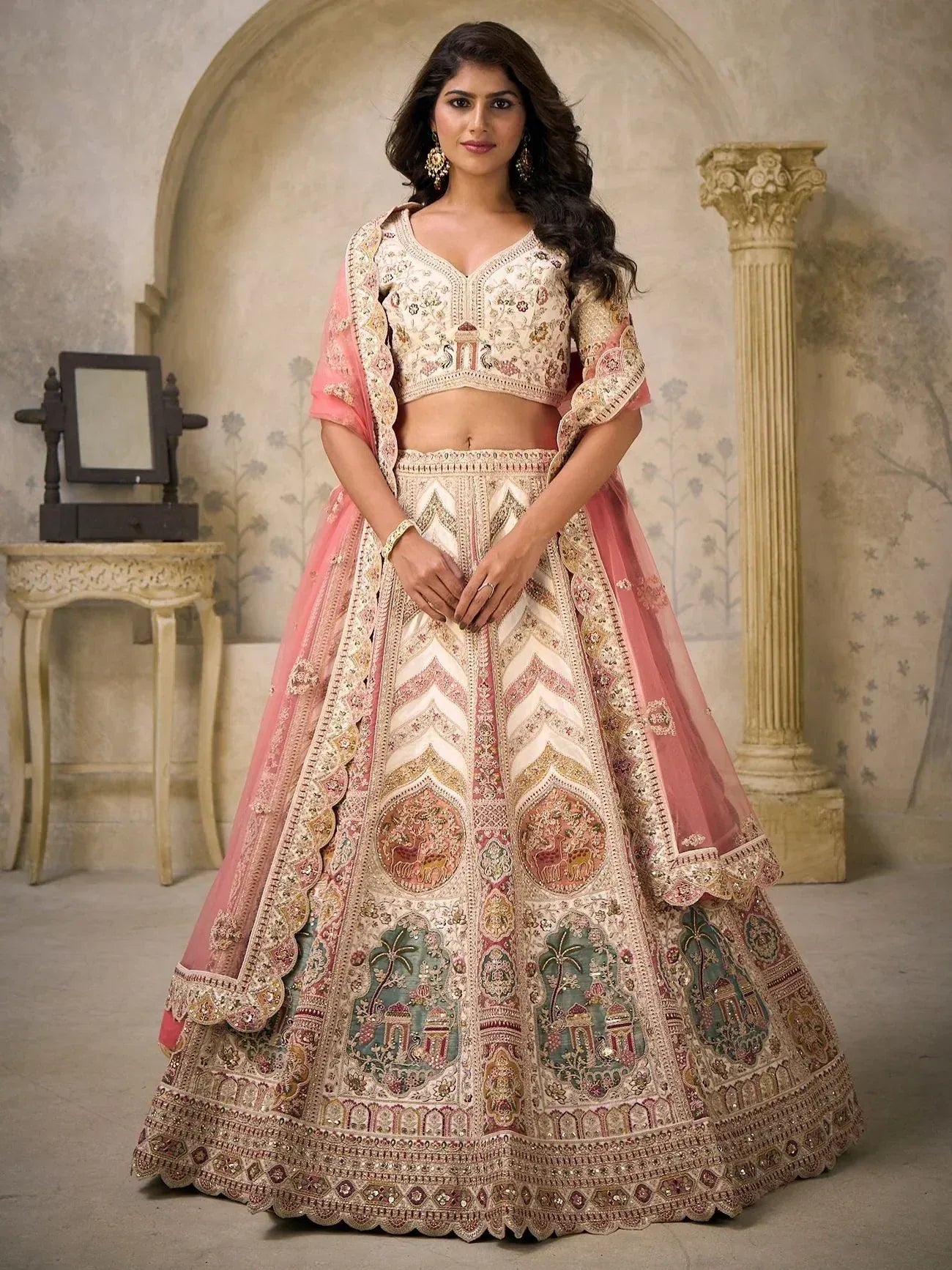 Elegant designer lehenga choli with intricate embroidery and pink dupatta, perfect for Indian weddings and festive occasions.