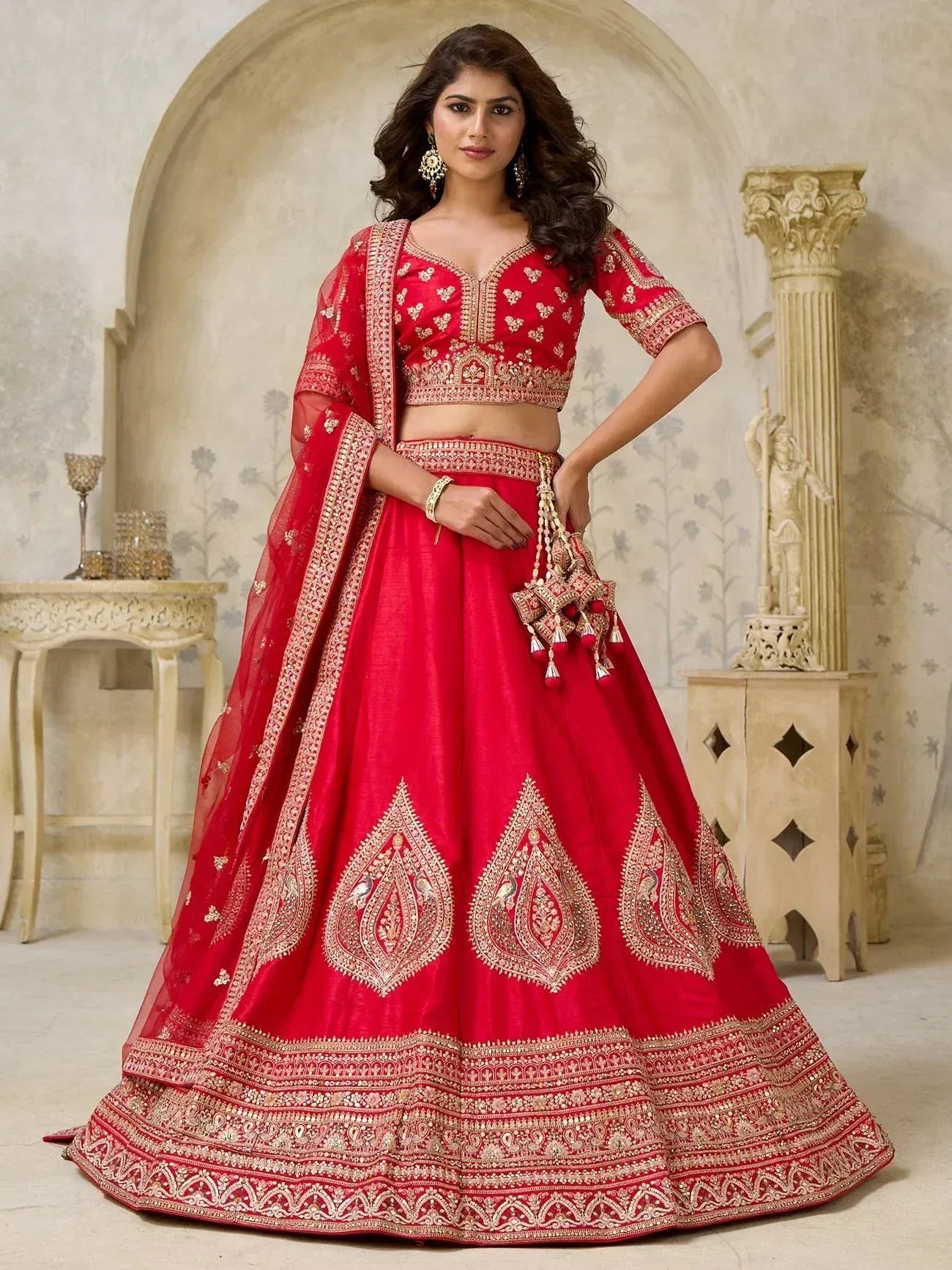 Red embroidered lehenga choli with gold detailing, perfect for Indian weddings and festive occasions