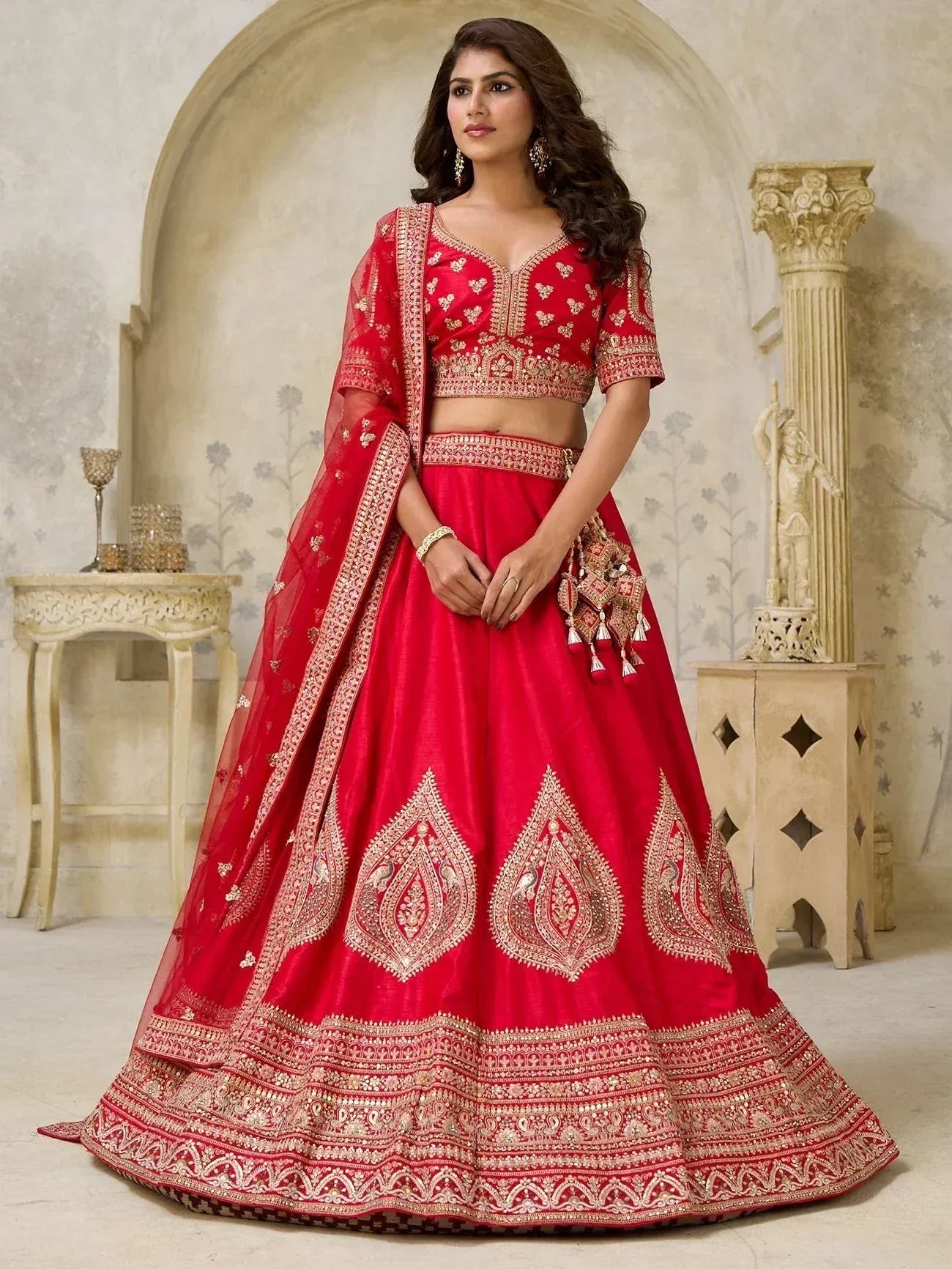 Red embroidered lehenga choli with gold detailing, perfect for Indian weddings and festive occasions