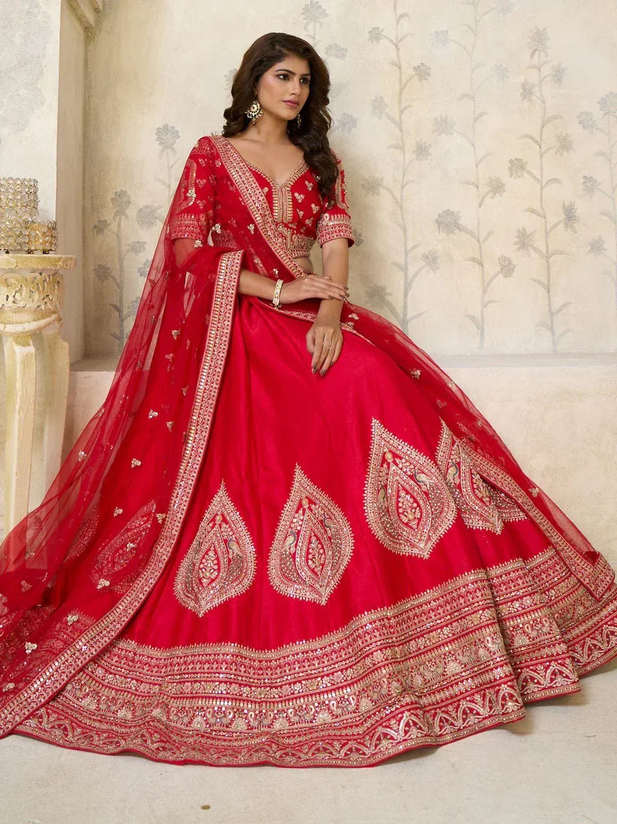 Red designer lehenga choli with gold embroidery, perfect for Indian weddings and festive occasions