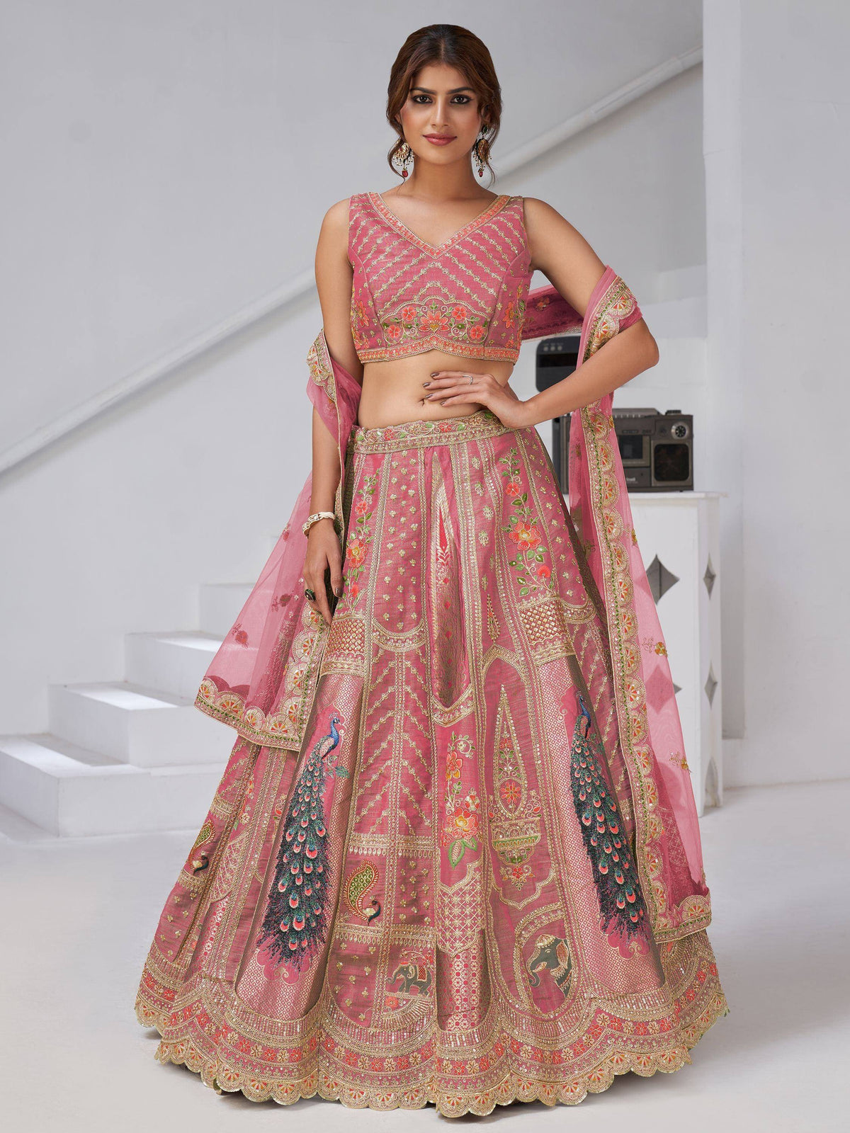 Pink embroidered lehenga choli with peacock and floral motifs, perfect for Indian weddings and festive occasions