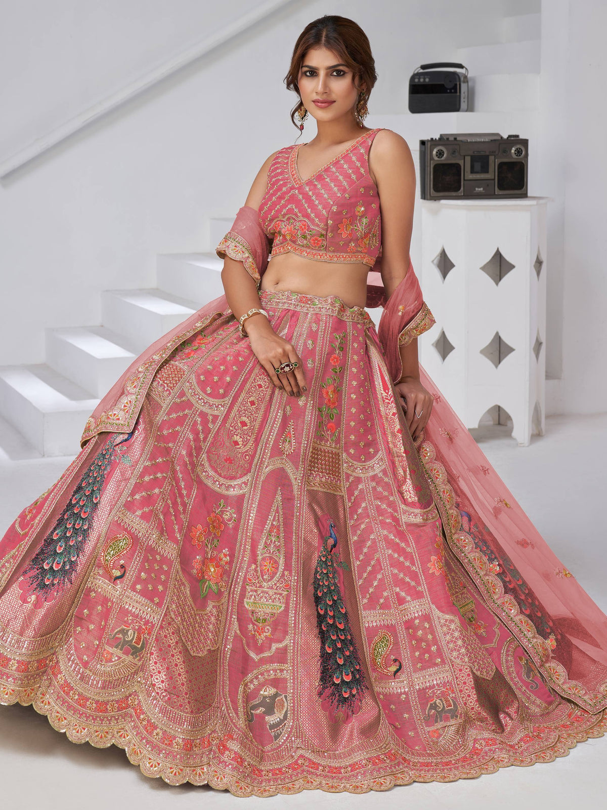 Pink embroidered lehenga choli with peacock and floral designs, perfect for Indian ethnic wear.