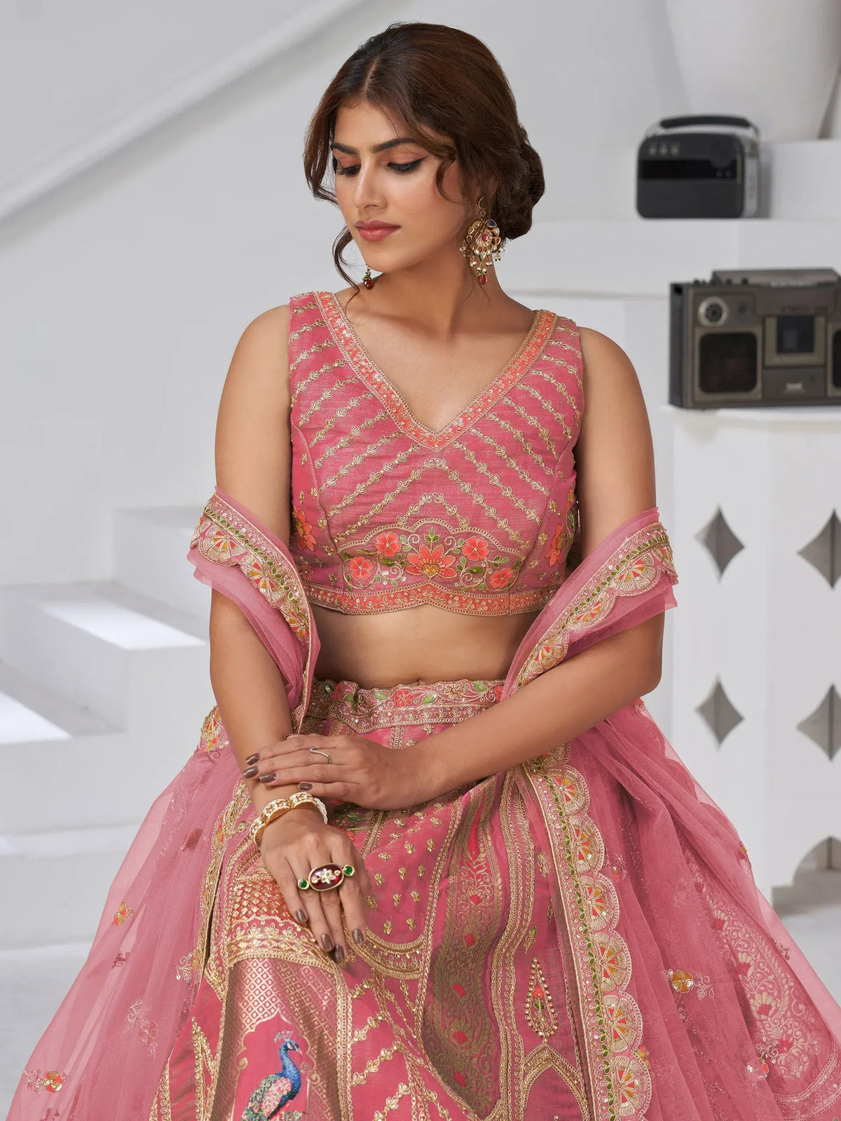 Pink embroidered lehenga choli with peacock motifs, perfect for Indian ethnic wear events