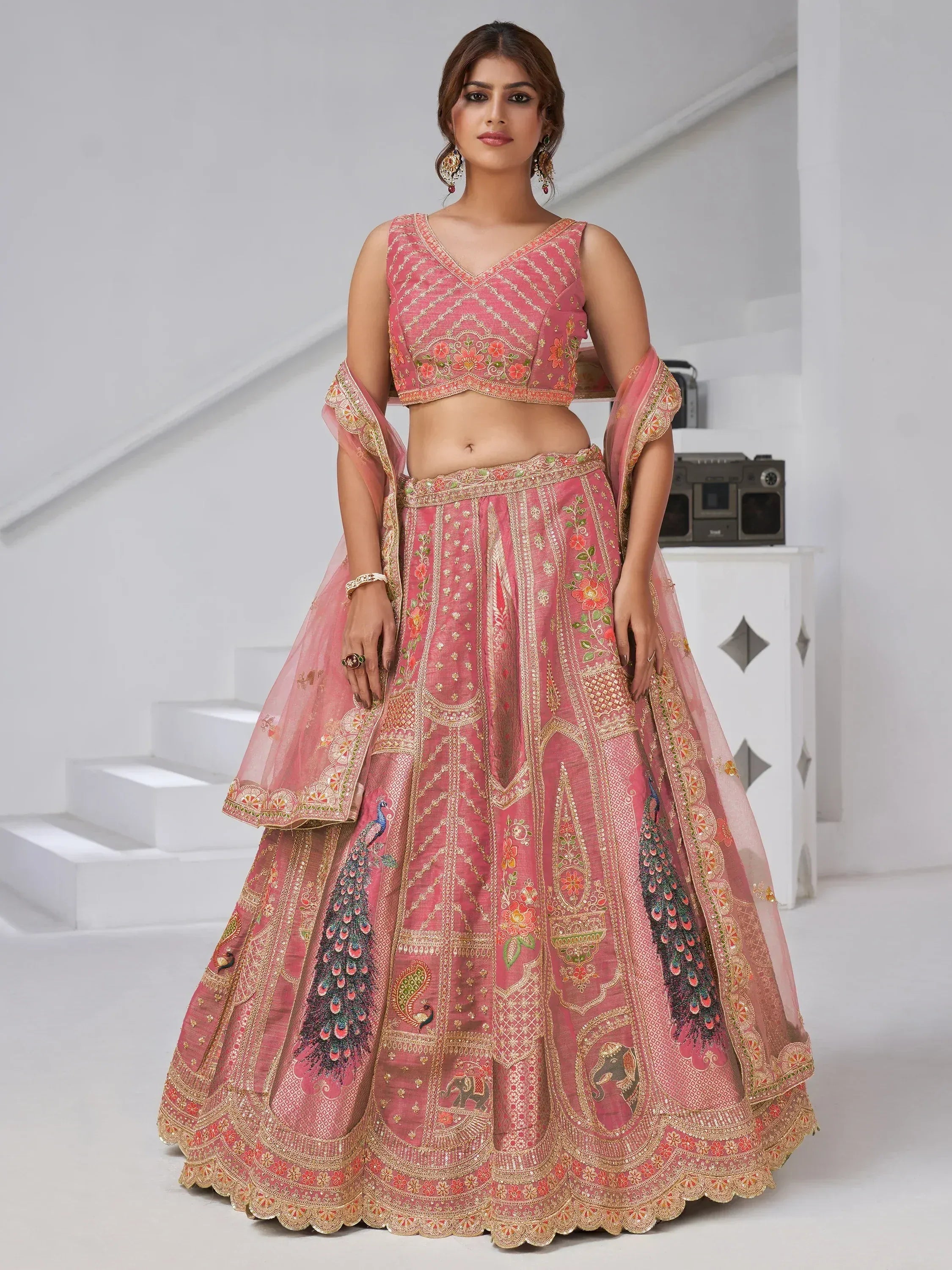 Pink embroidered lehenga choli with peacock and floral motifs, perfect for Indian ethnic wear occasions