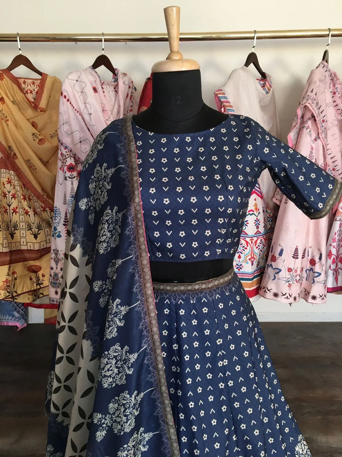 Blue floral print Indian ethnic salwar kameez with dupatta on mannequin, traditional designer wear