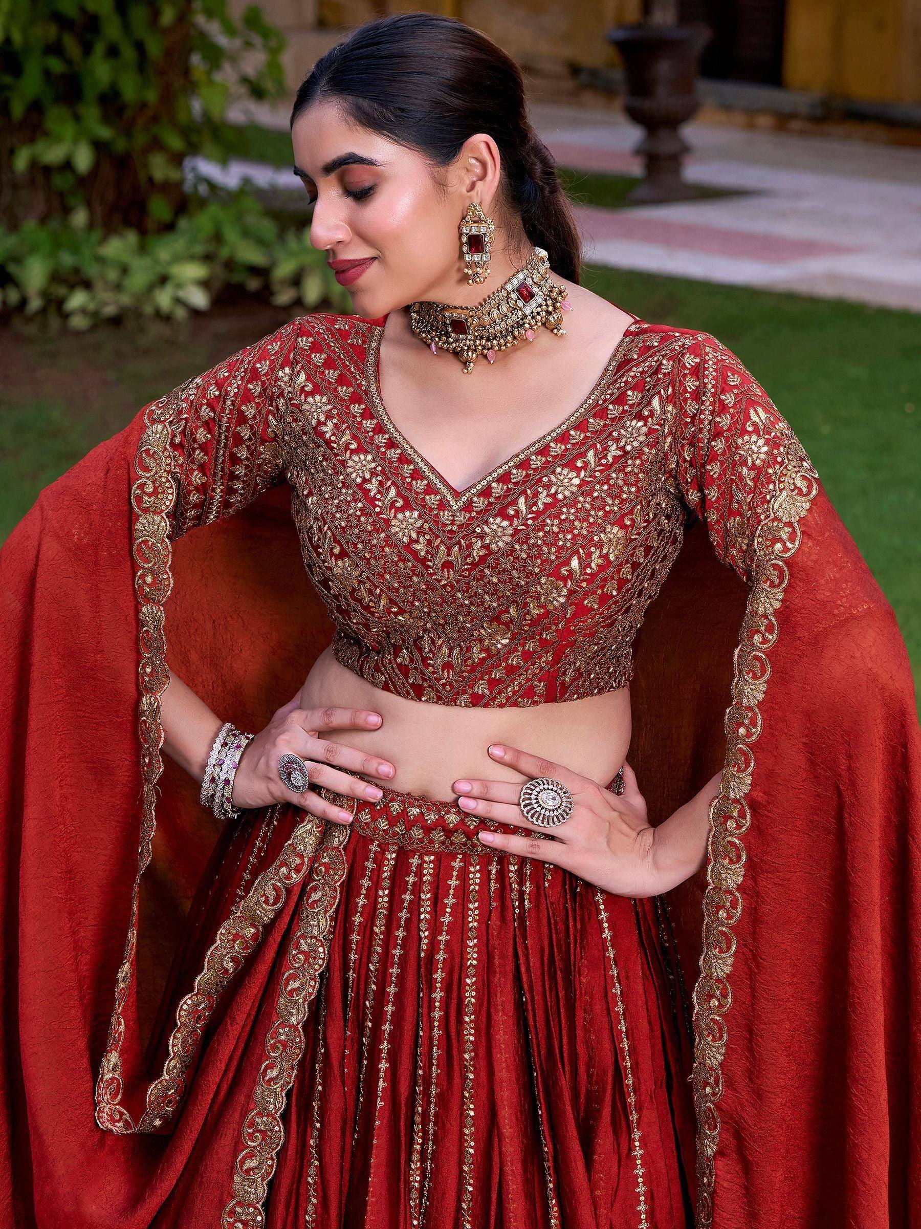 Red and gold embroidered lehenga choli with cape, perfect for Indian weddings and festive occasions