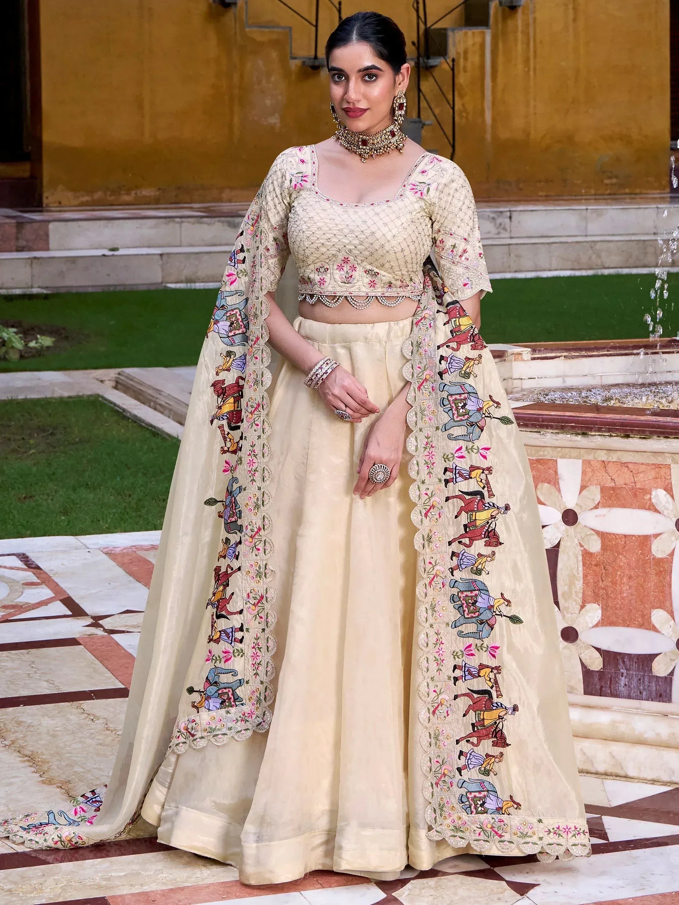 Cream embroidered lehenga choli with elephant motifs, perfect for Indian weddings and festive occasions