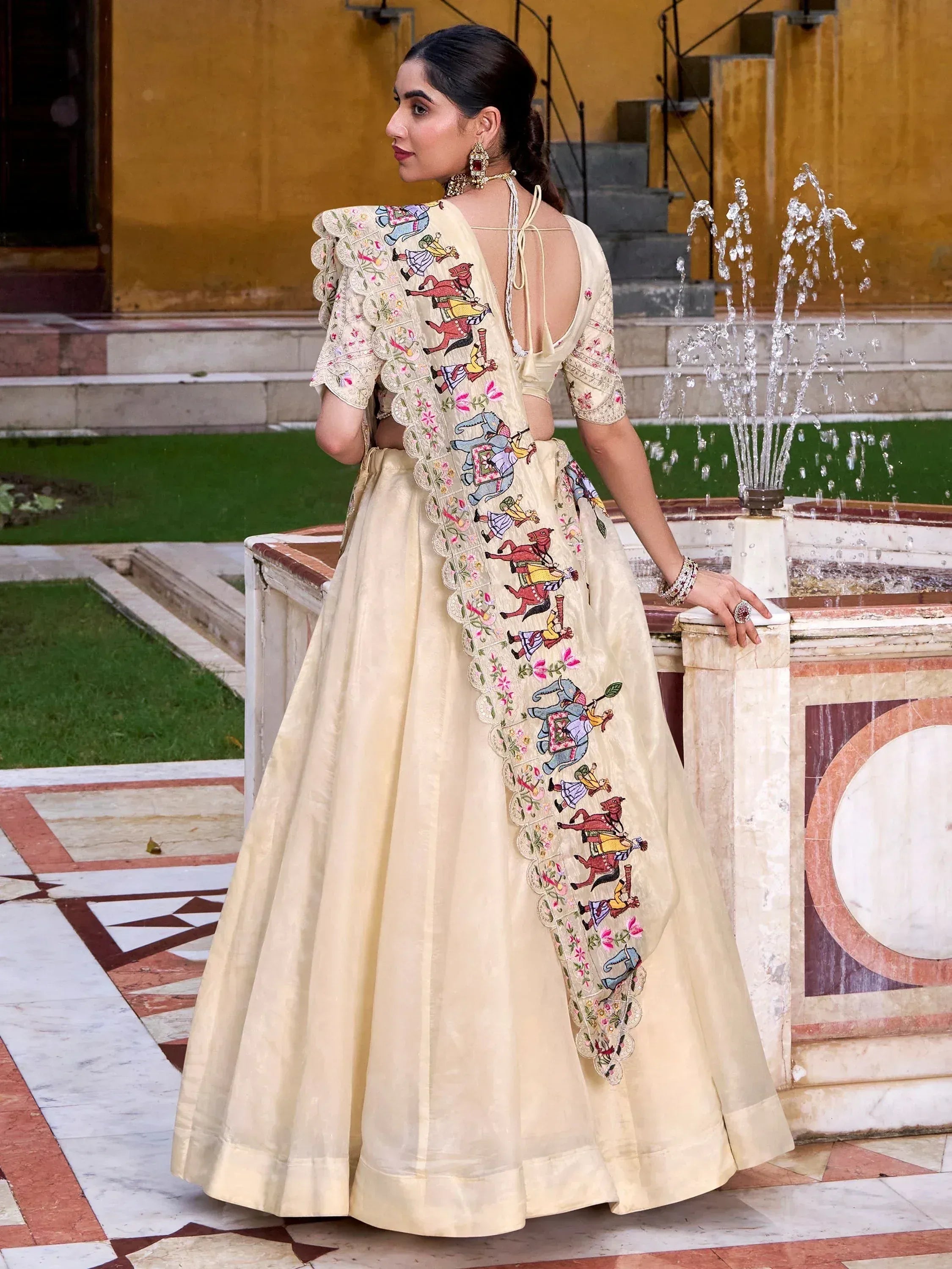 Cream embroidered lehenga choli with folk art dupatta, perfect for Indian ethnic occasions