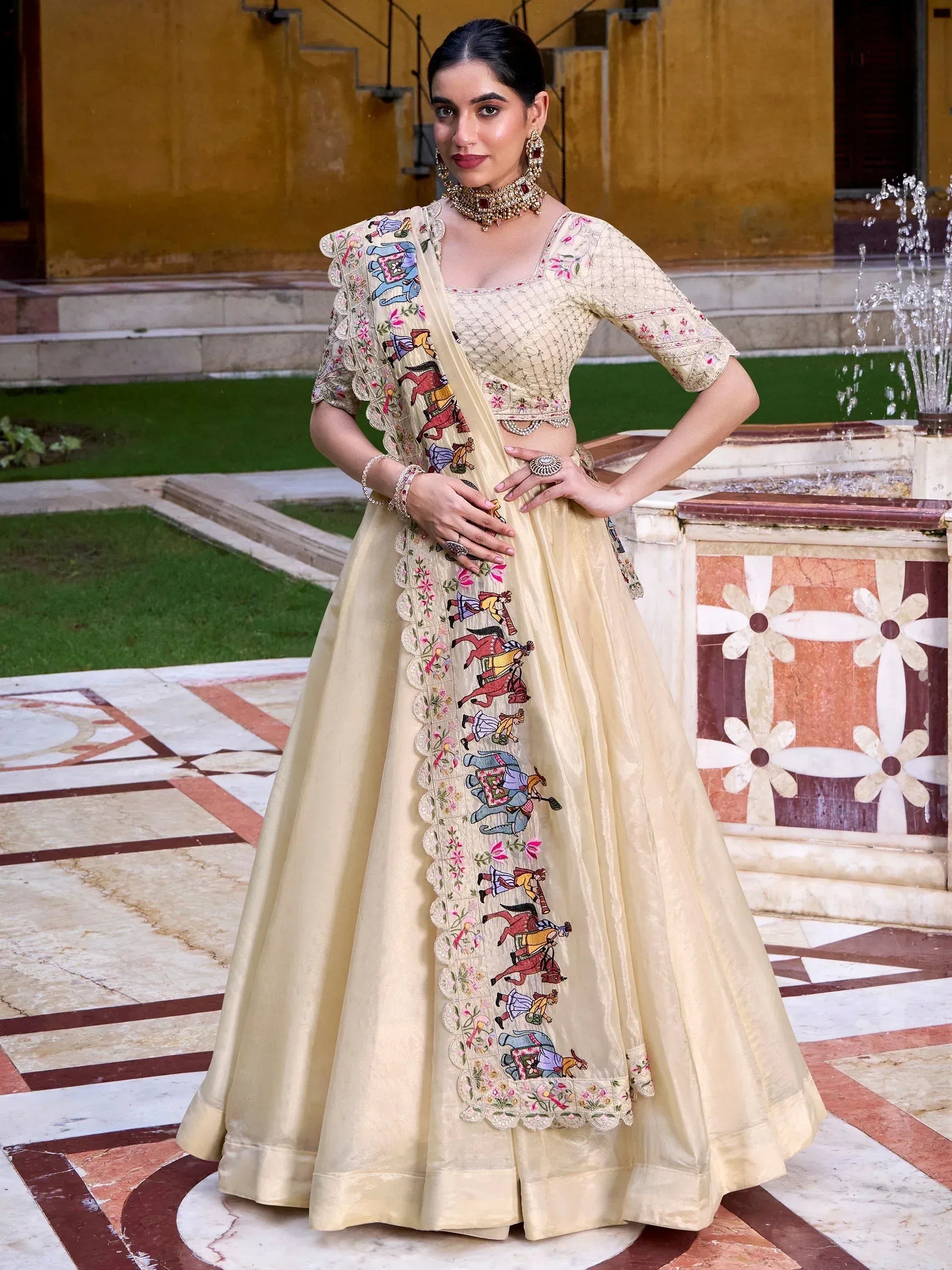 Cream embroidered lehenga choli with horse & elephant motifs, perfect for Indian ethnic wear events