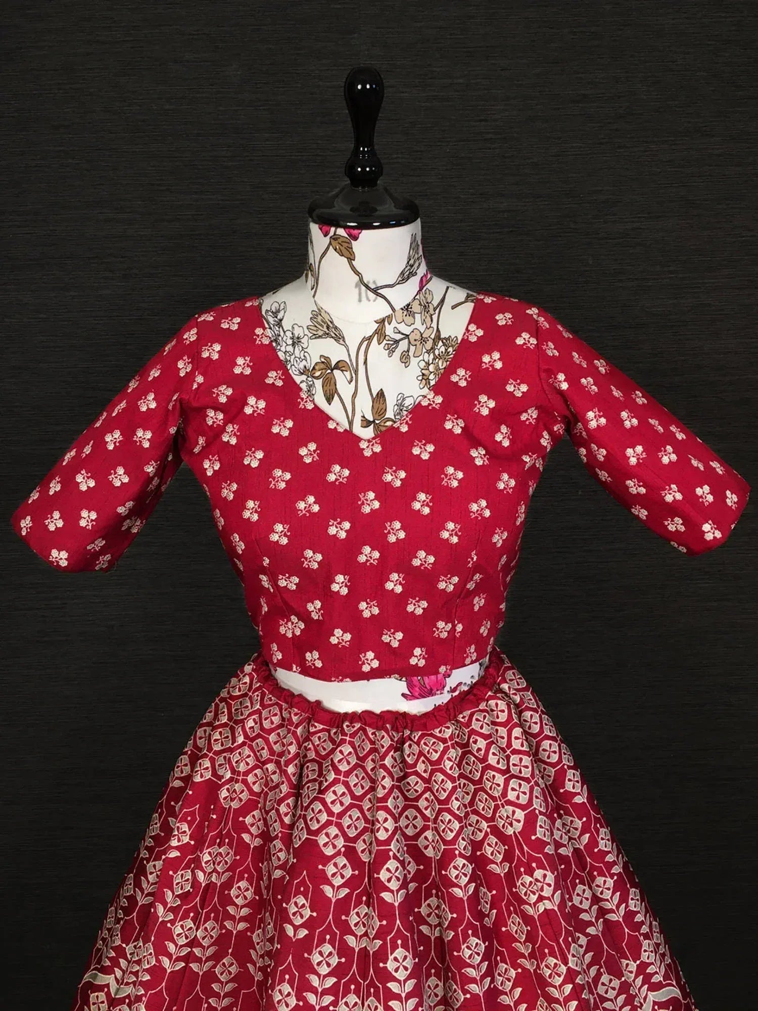 Red floral print ethnic gown with V-neck and flared skirt, perfect for Indian occasions