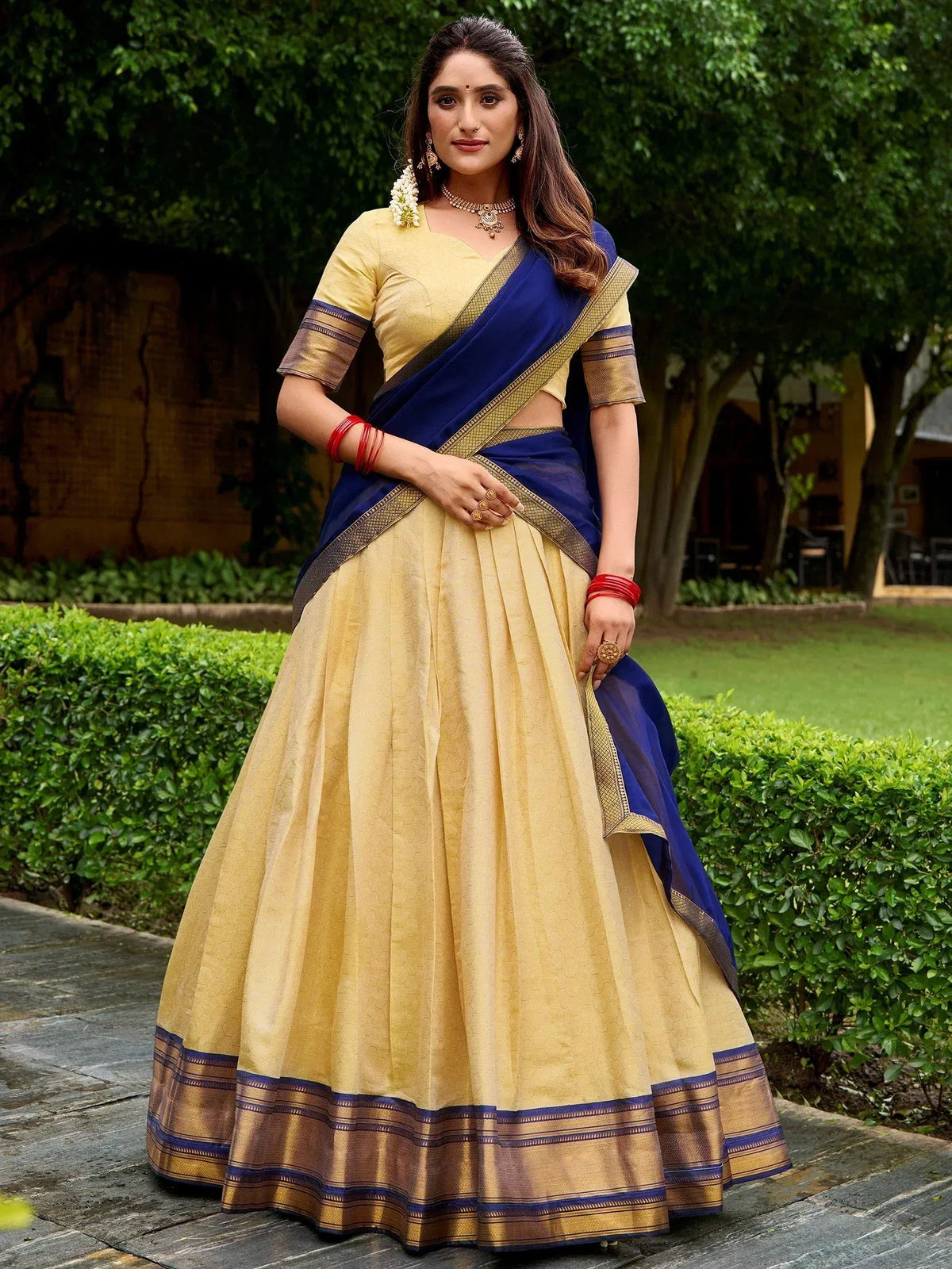 Elegant yellow and blue lehenga choli with golden border, perfect for Indian ethnic occasions
