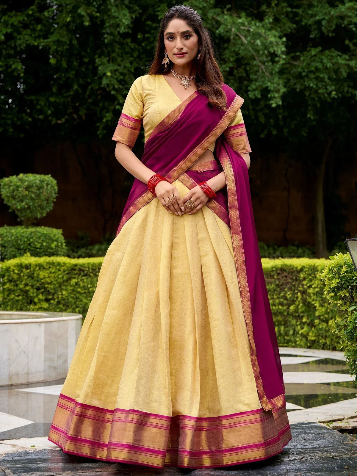 Yellow and magenta designer lehenga choli with gold border, perfect for Indian ethnic occasions