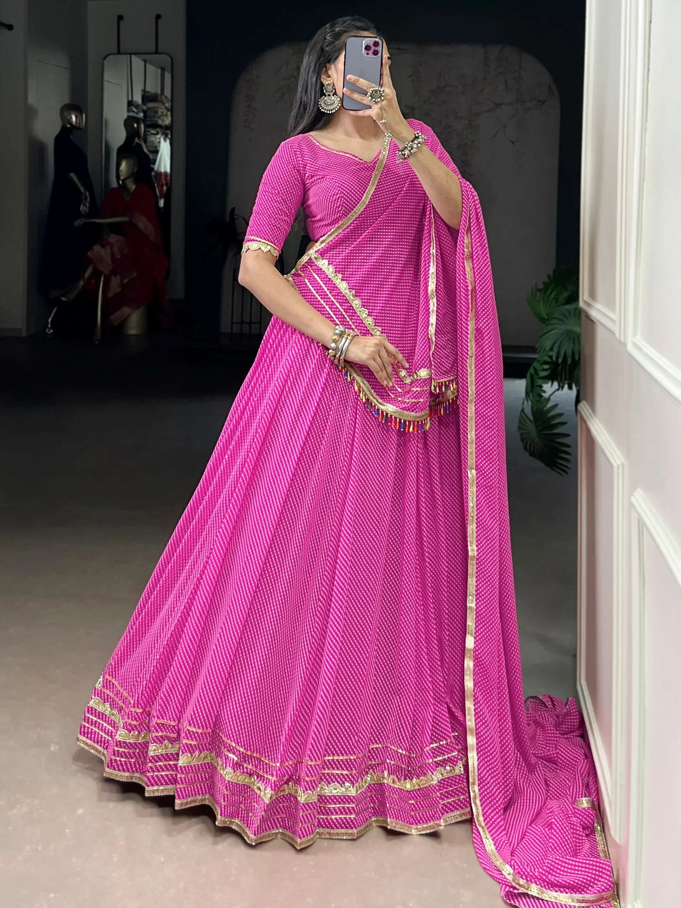 Pink ethnic lehenga choli with gold trim, perfect for Indian weddings and festive occasions