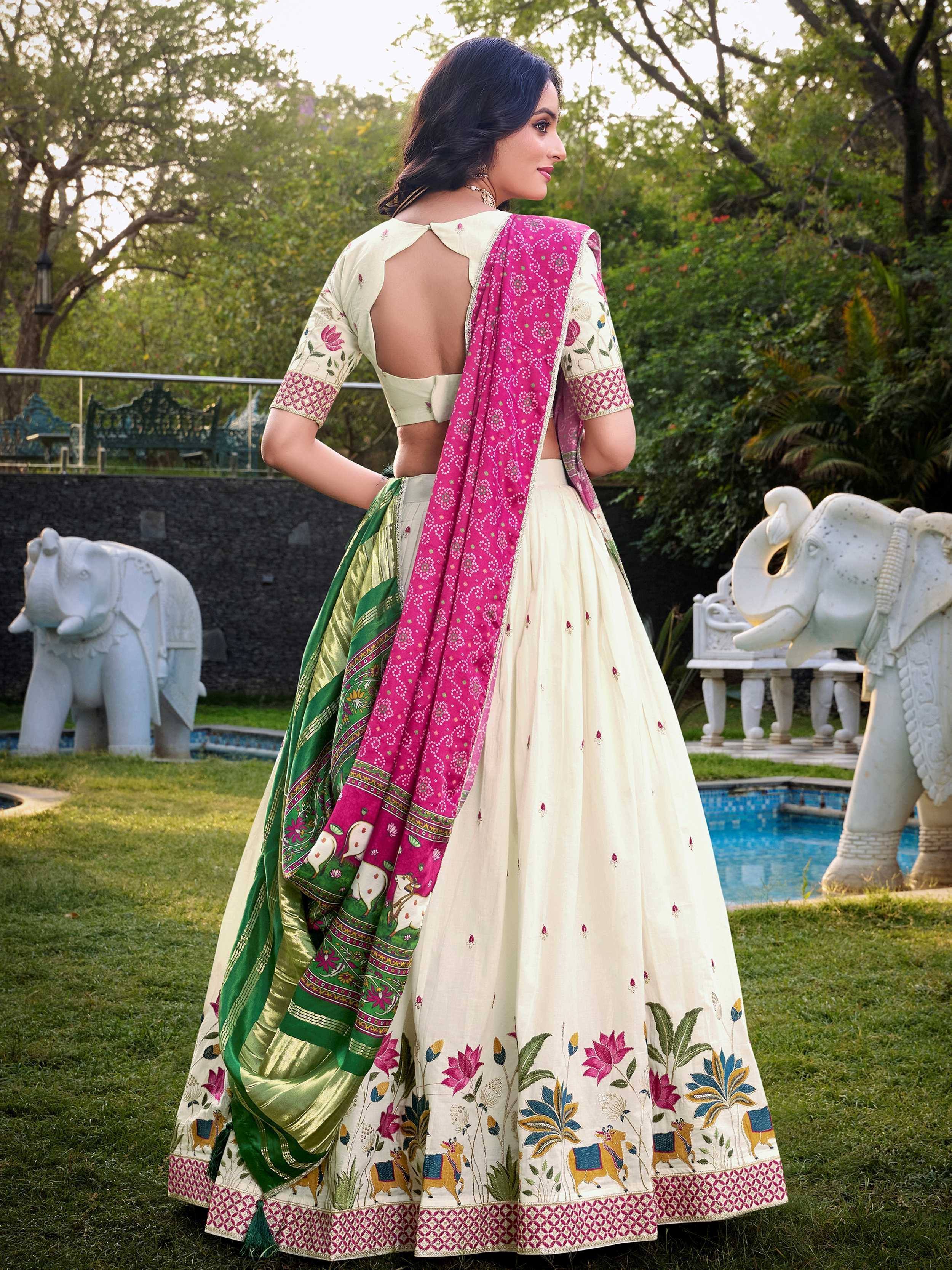 Cream floral embroidered lehenga choli with pink and green dupatta, garden setting
