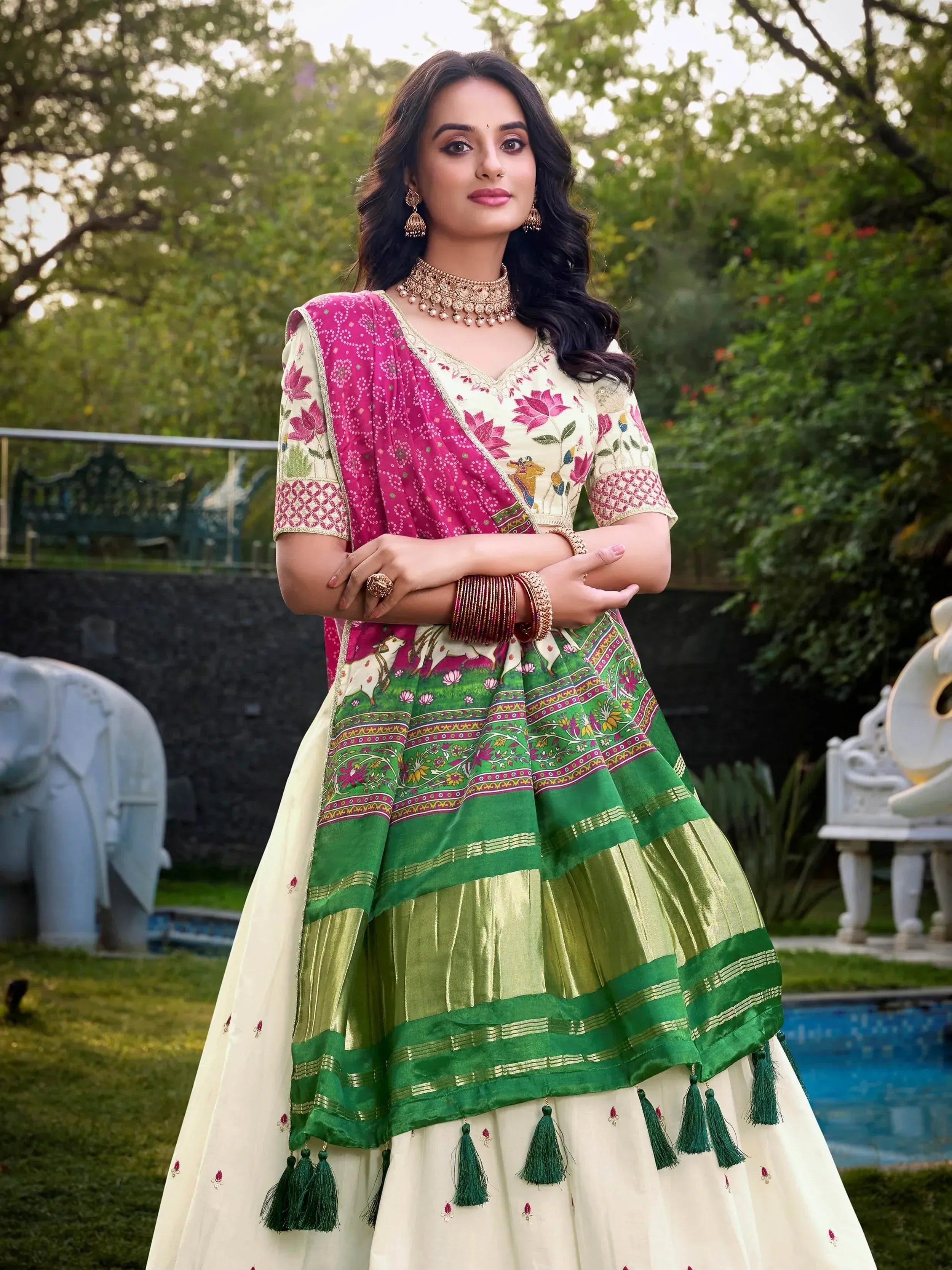 Woman in vibrant Indian ethnic wear with floral embroidery, green and pink lehenga choli, perfect for festive occasions.
