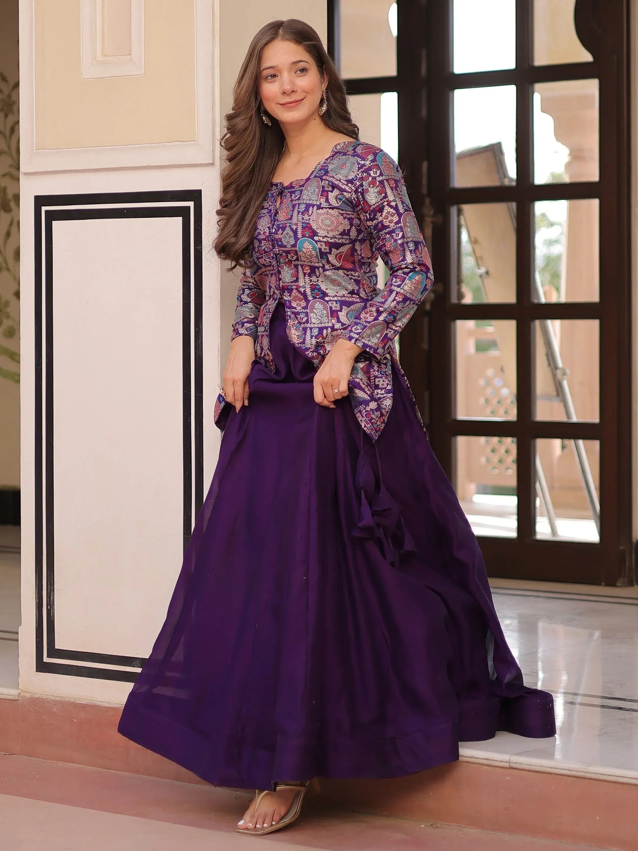 Purple printed ethnic gown with flared skirt, perfect for Indian occasions and festive wear.