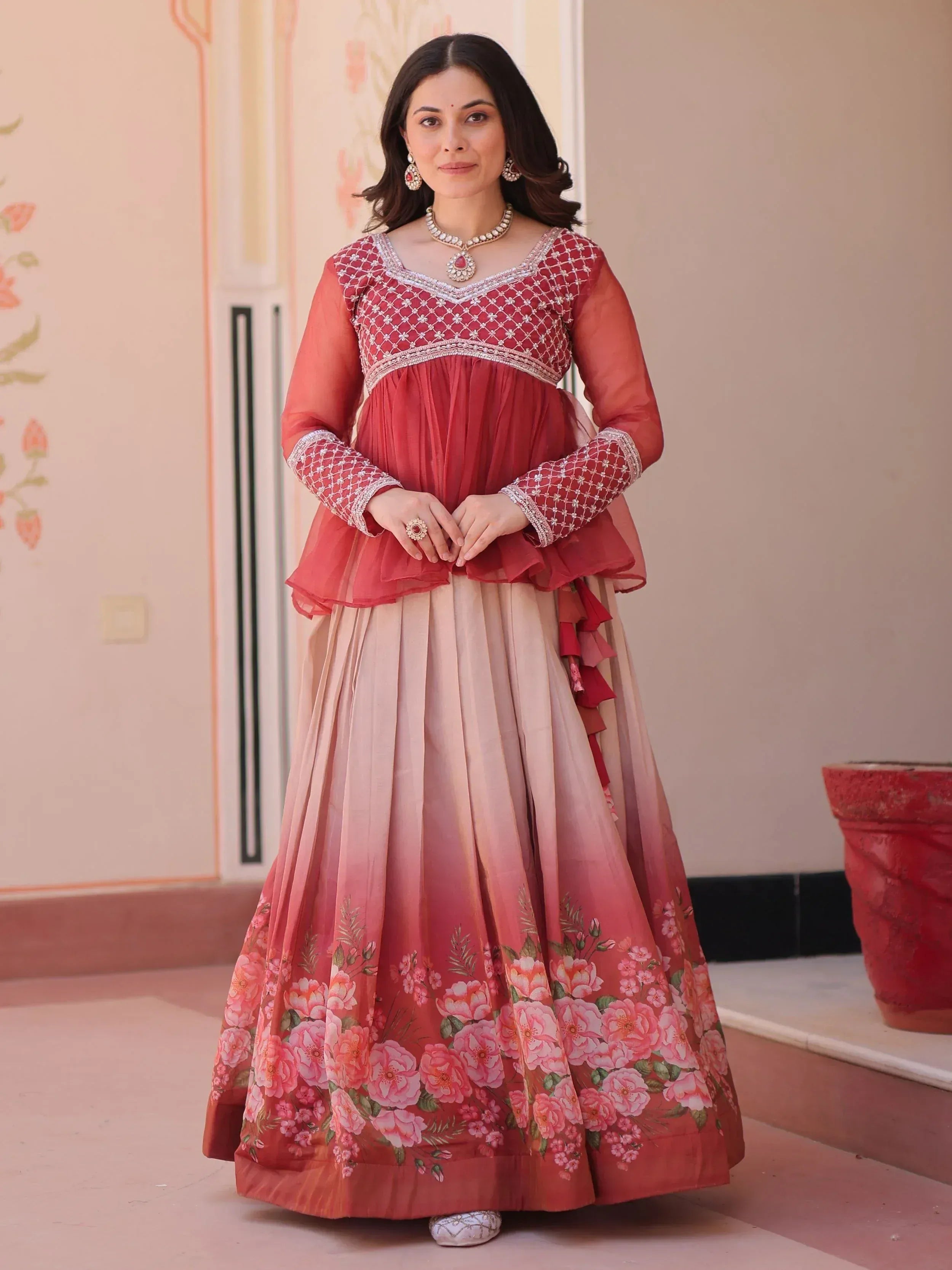 Woman in red embroidered blouse and floral print lehenga, Indian ethnic wear