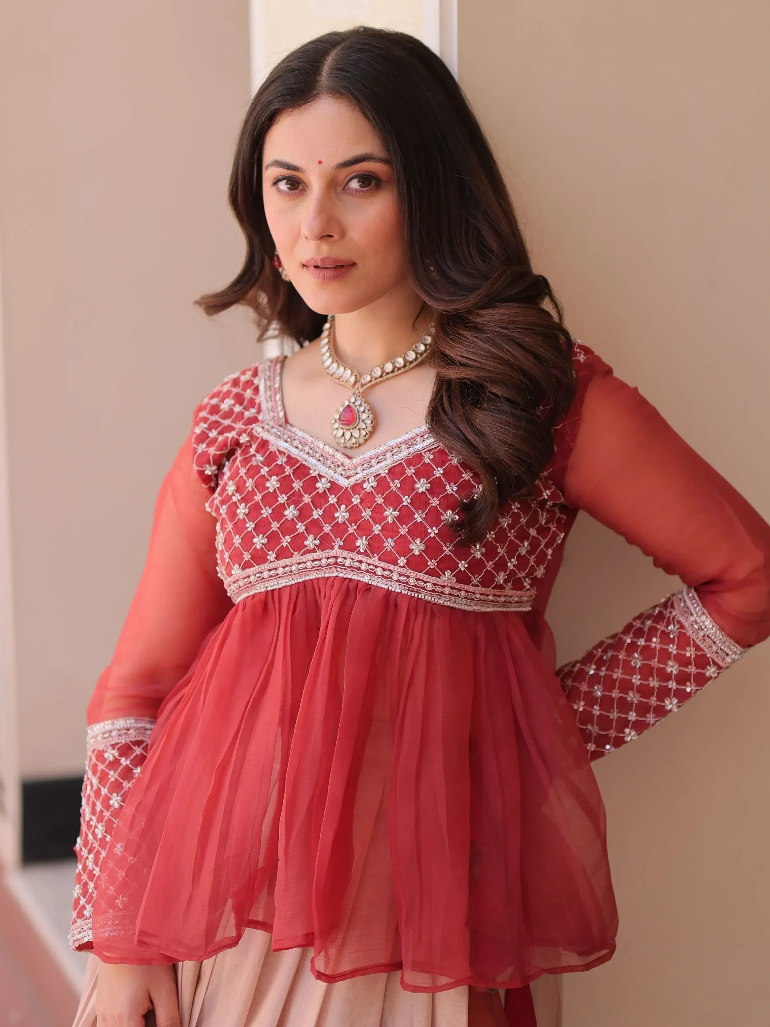 Red embroidered ethnic gown with sheer sleeves and dupatta, perfect for Indian weddings or festive occasions.