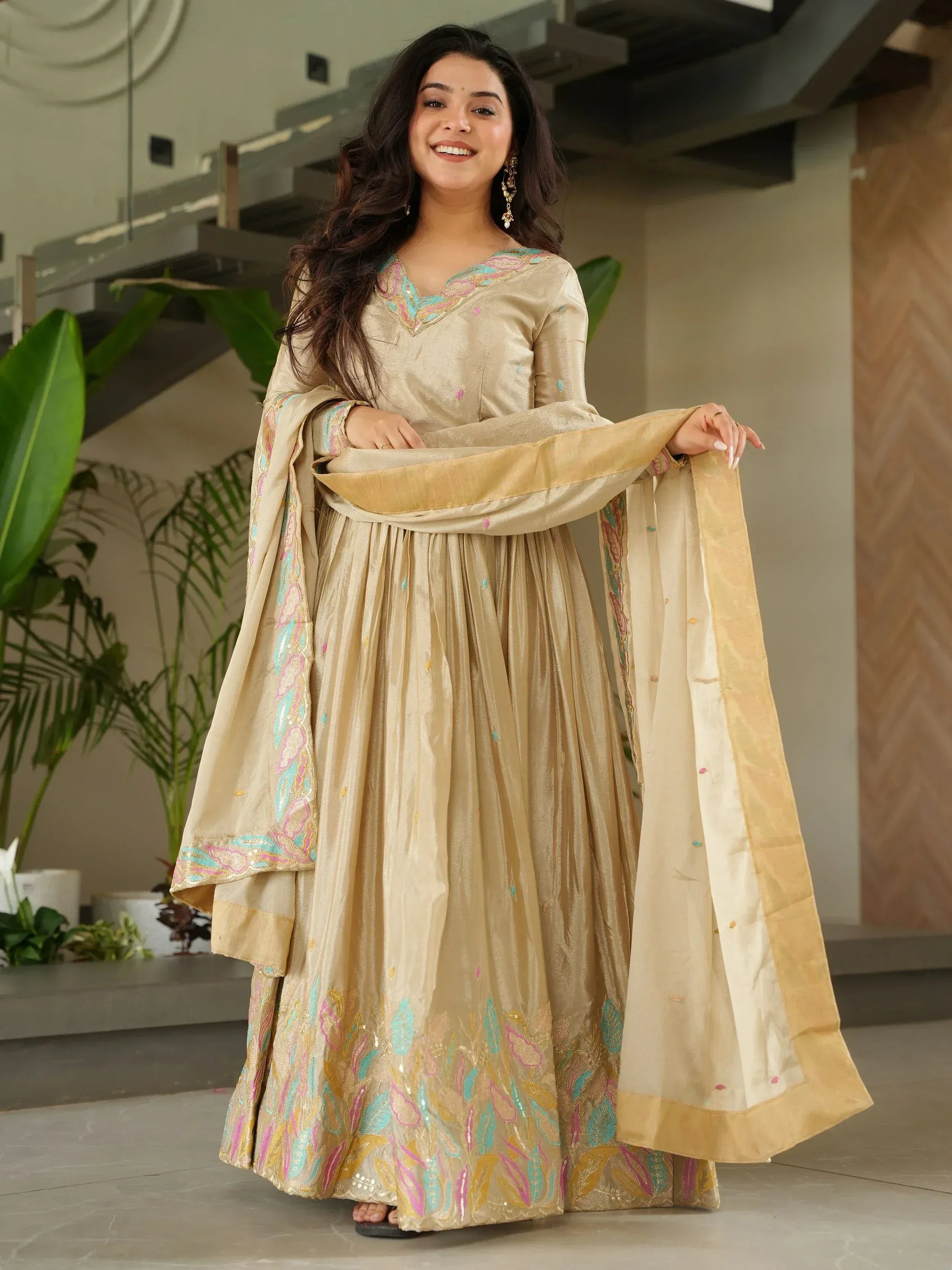 Elegant beige embroidered anarkali suit with colorful floral motifs and dupatta, perfect for Indian ethnic occasions