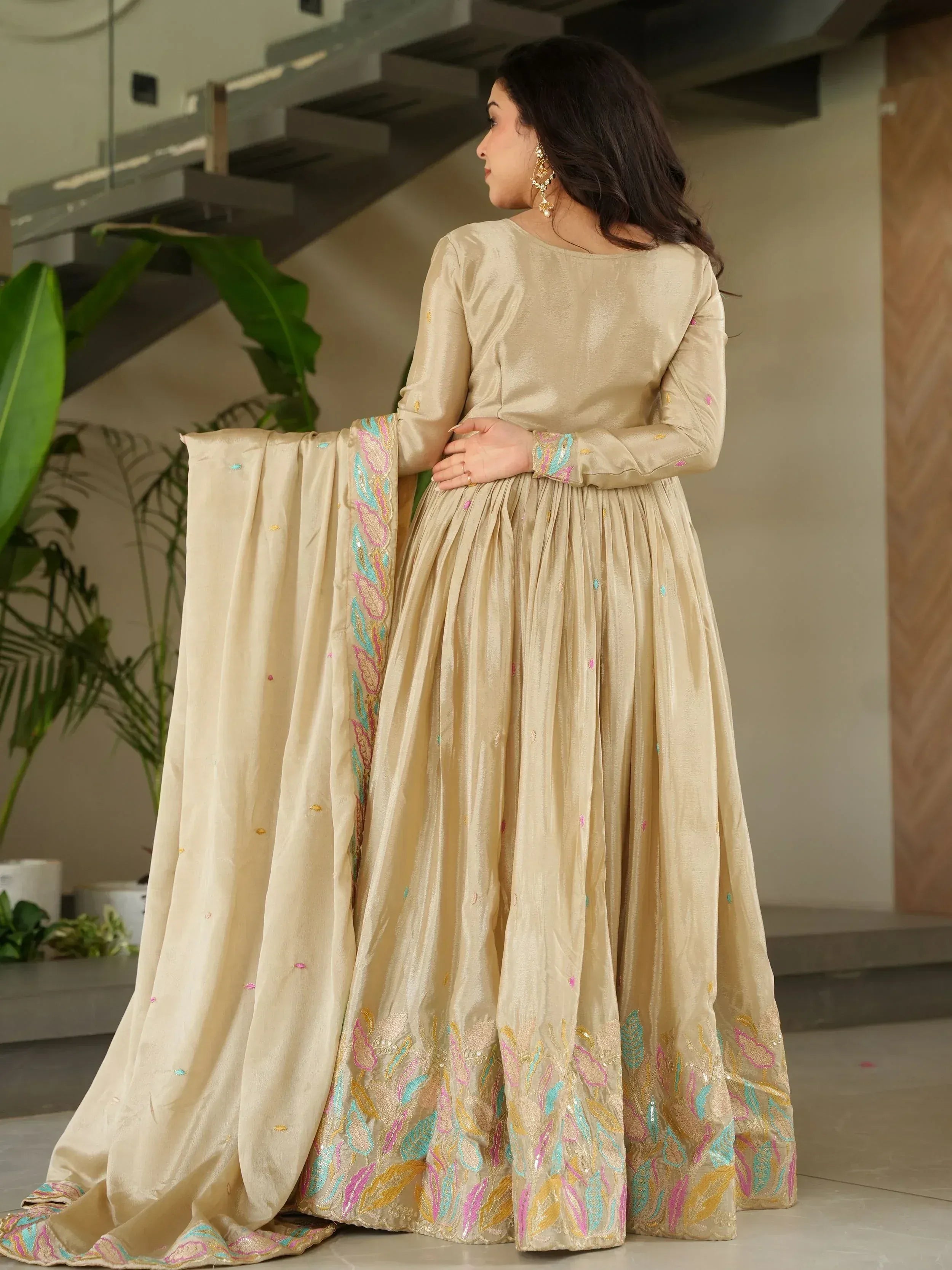 Beige embroidered anarkali with colorful floral border, perfect for Indian ethnic wear occasions.