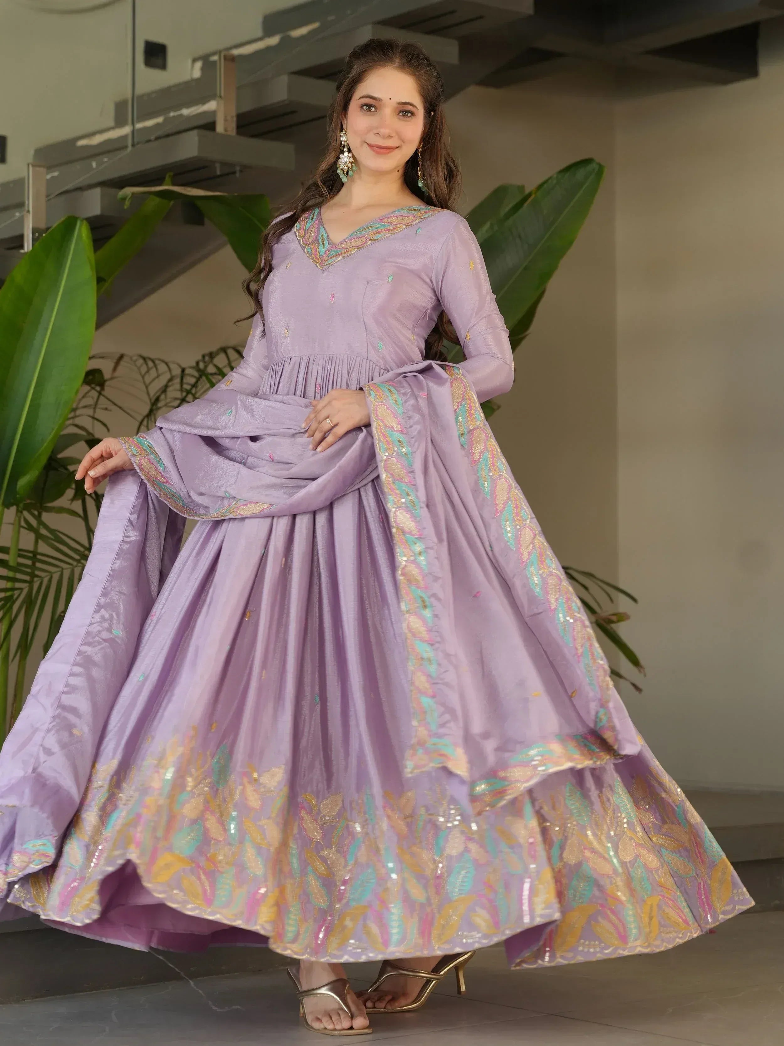 Lavender ethnic gown with colorful embroidery, perfect for Indian occasions and festive wear.