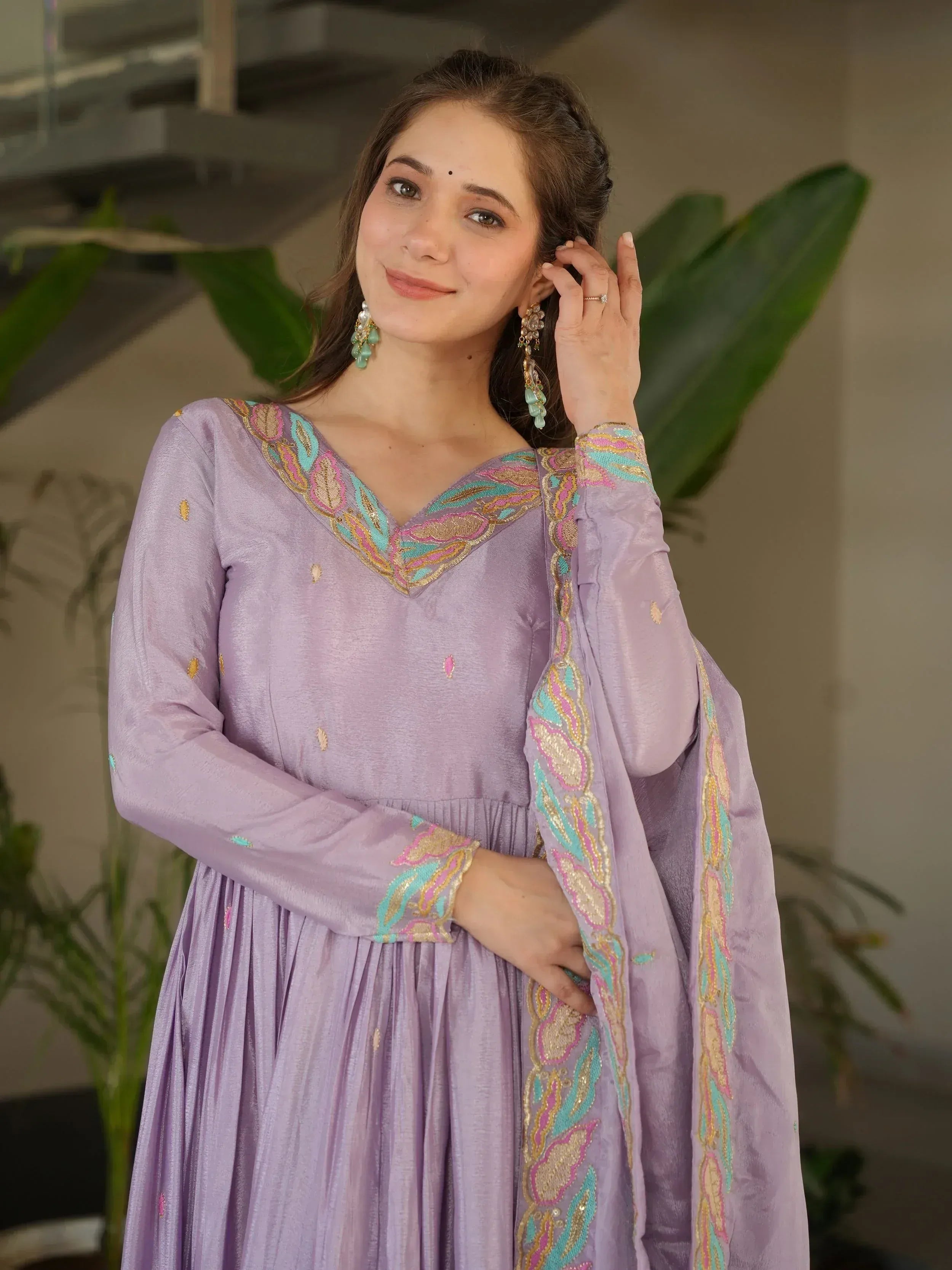 Lavender ethnic gown with colorful embroidery, perfect for Indian celebrations and festive occasions.
