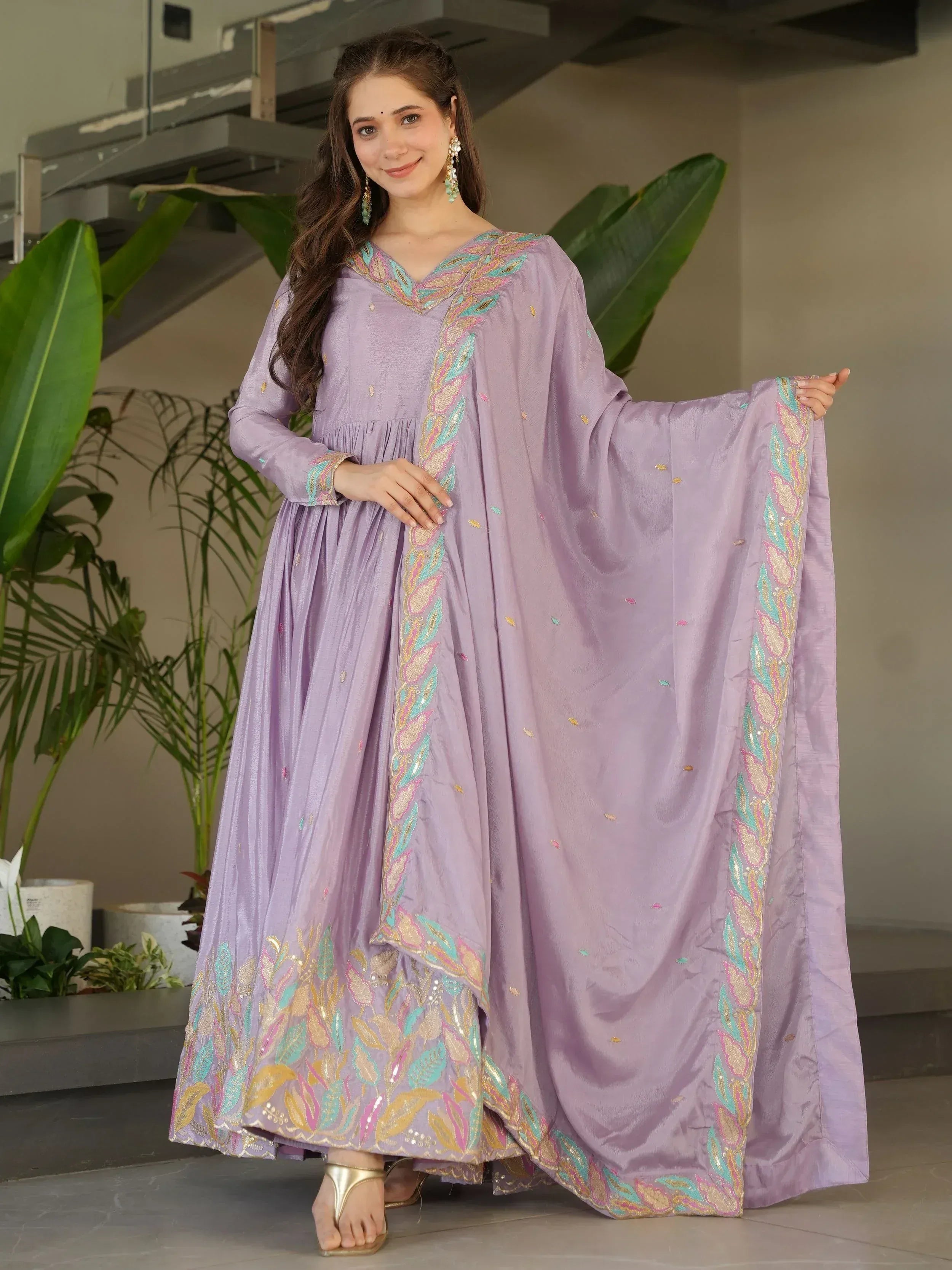 Lavender ethnic gown with floral embroidery, perfect for Indian occasions and festive wear.