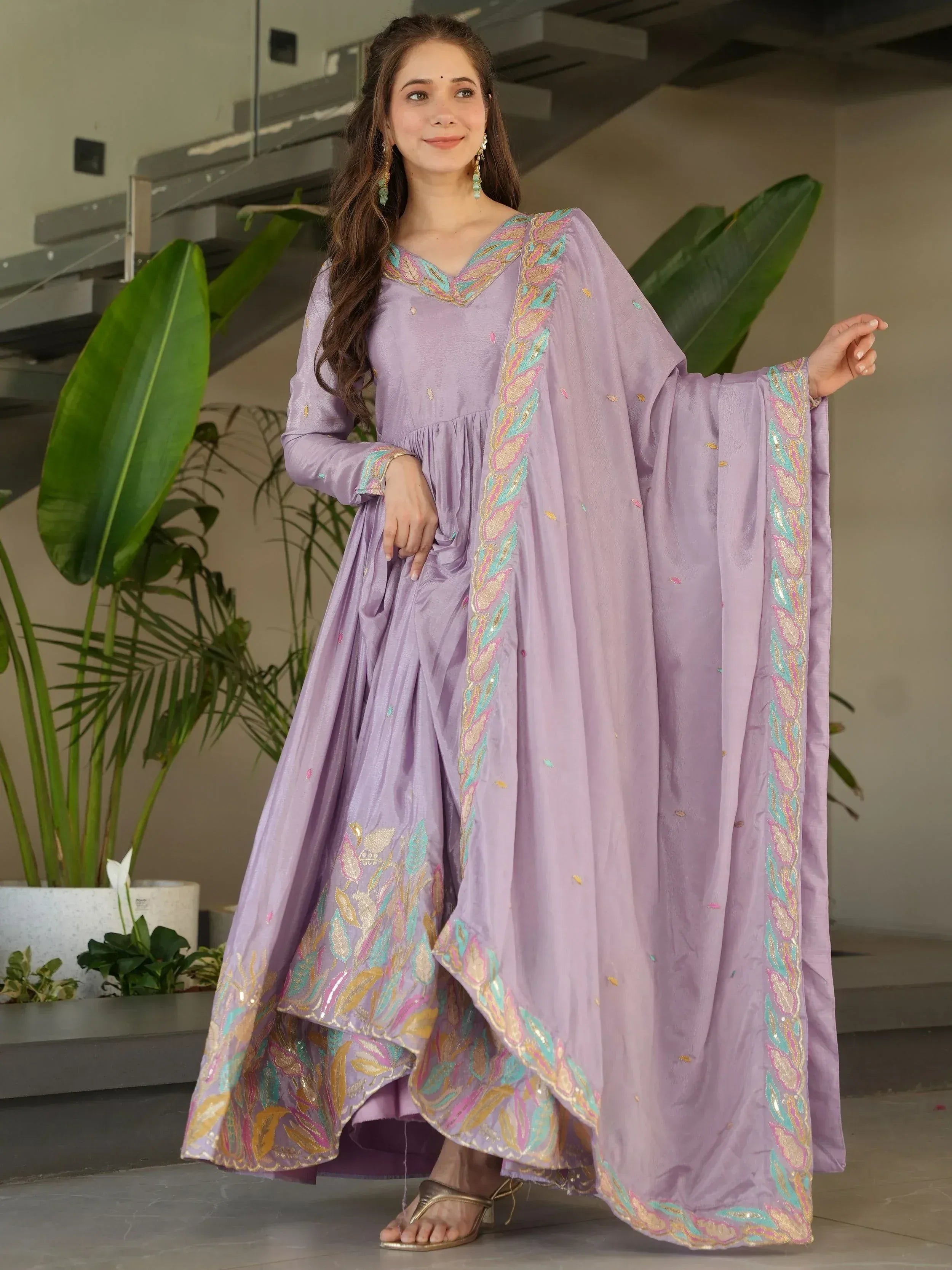 Lavender ethnic gown with colorful embroidery, perfect for Indian occasions and festive wear.