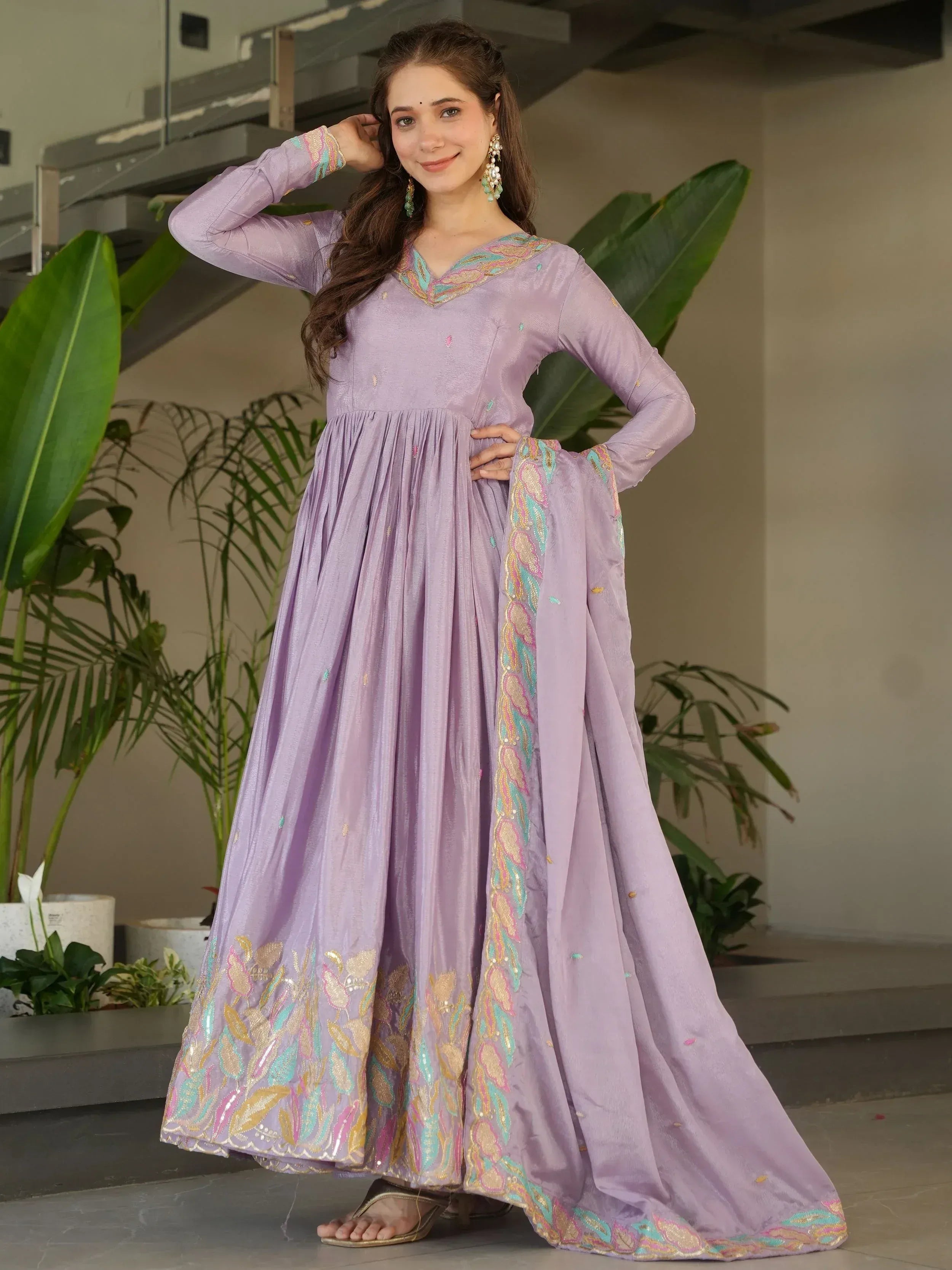 Lavender ethnic gown with colorful embroidery, perfect for Indian occasions and festive wear.