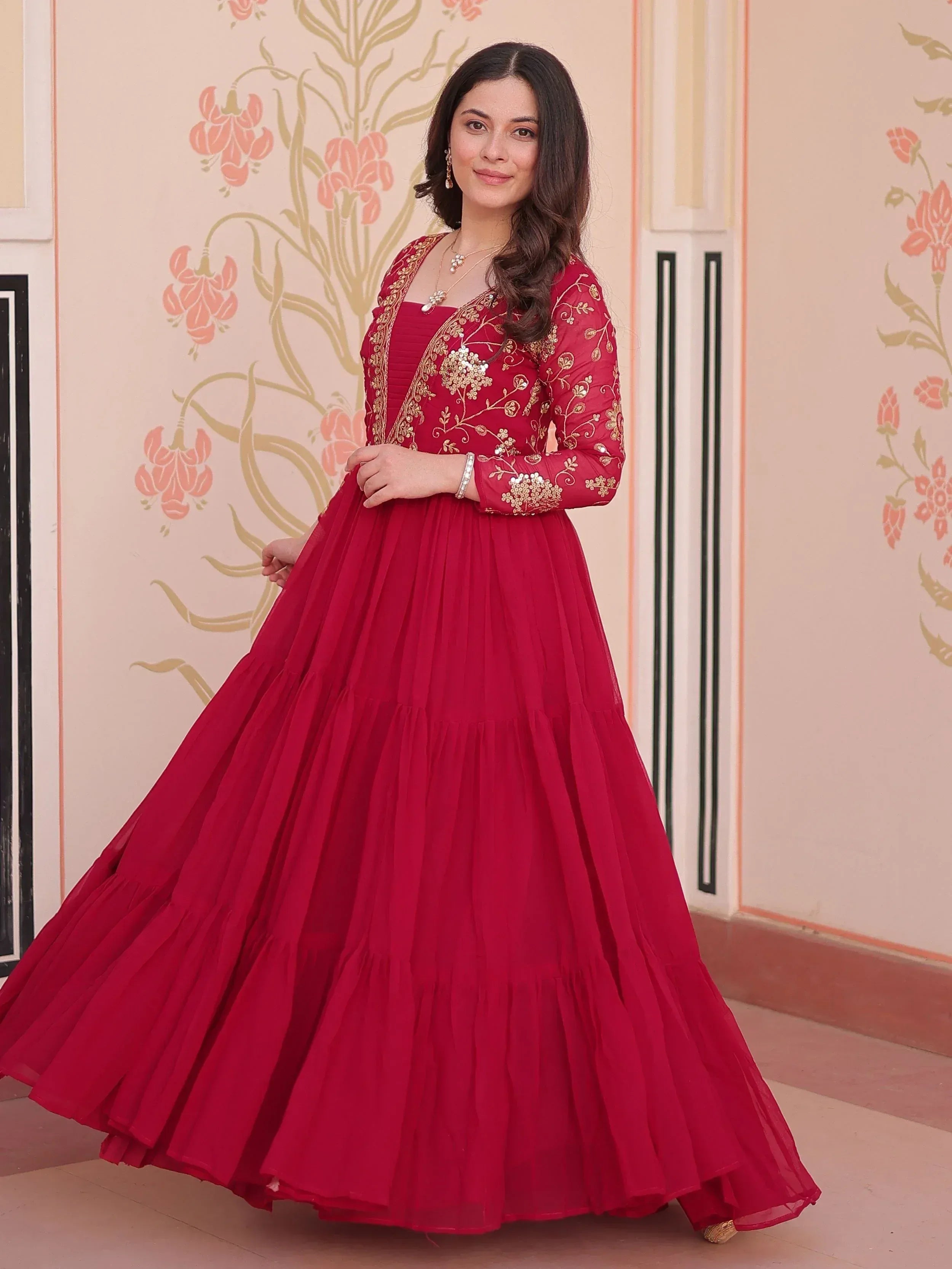 Red ethnic gown with gold embroidery, perfect for Indian celebrations and festive occasions.