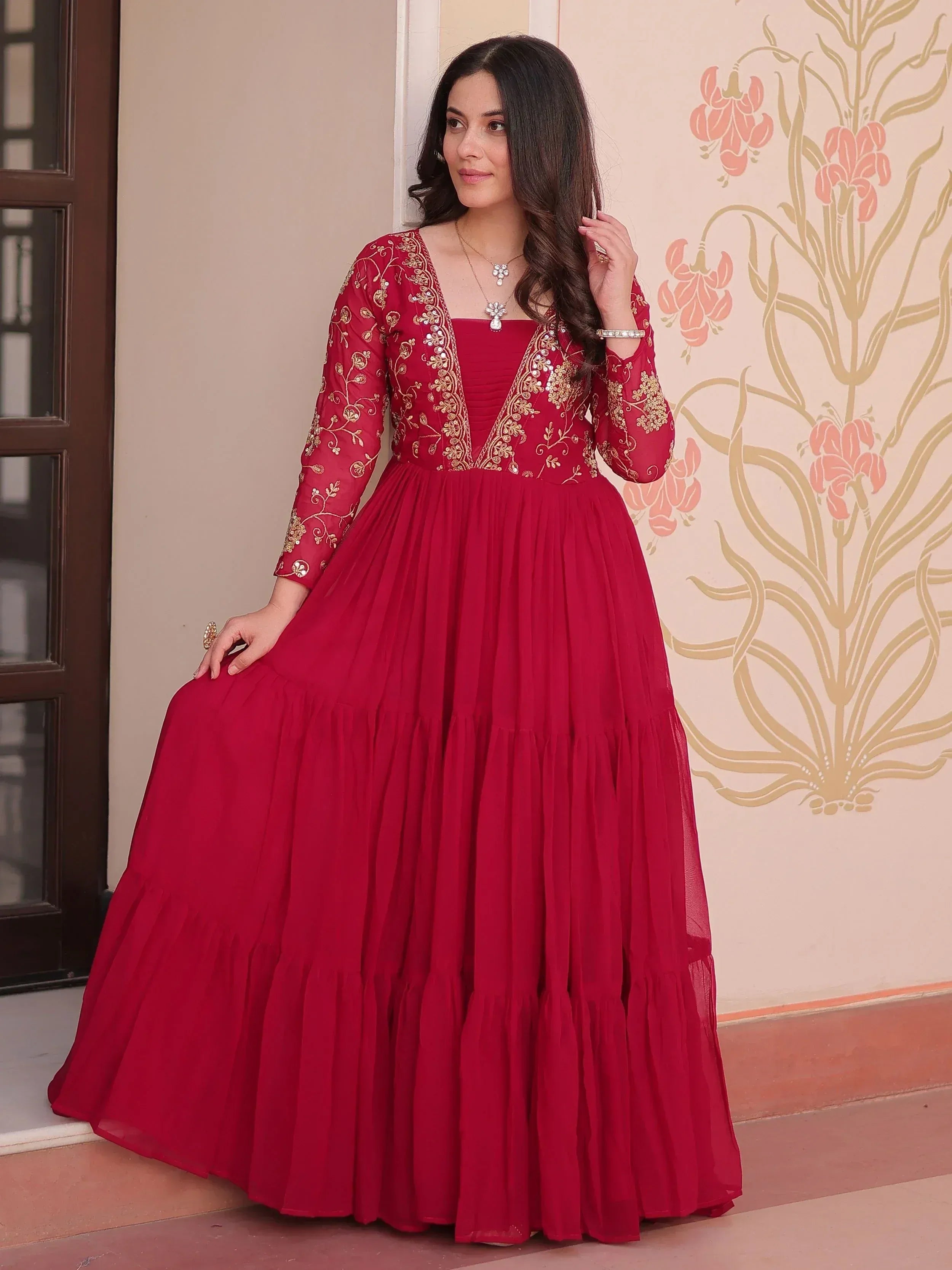 Red embroidered ethnic gown with gold detailing, perfect for Indian occasions and festive wear.