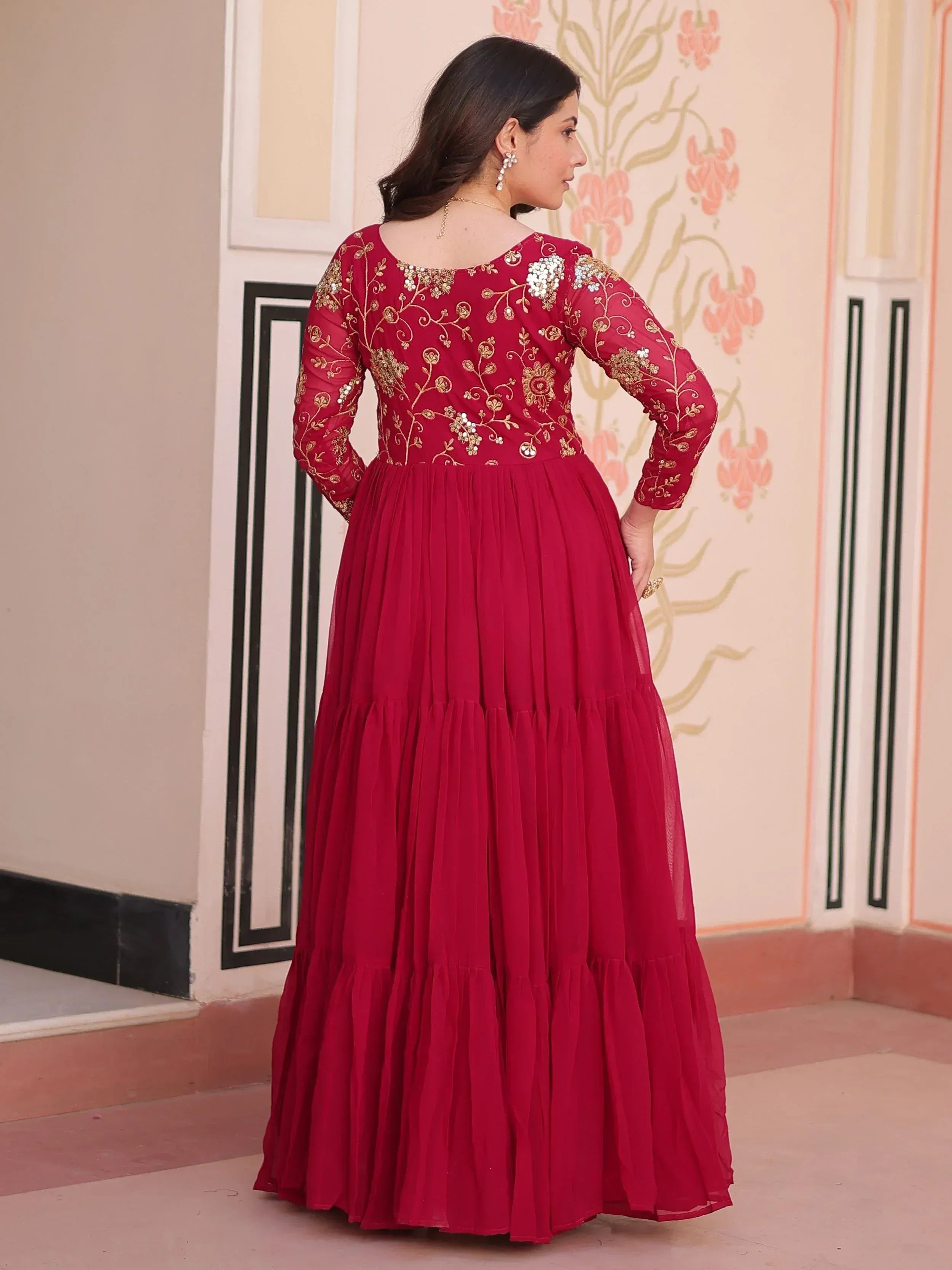 Red ethnic gown with gold embroidery and pleated skirt, perfect for Indian occasions