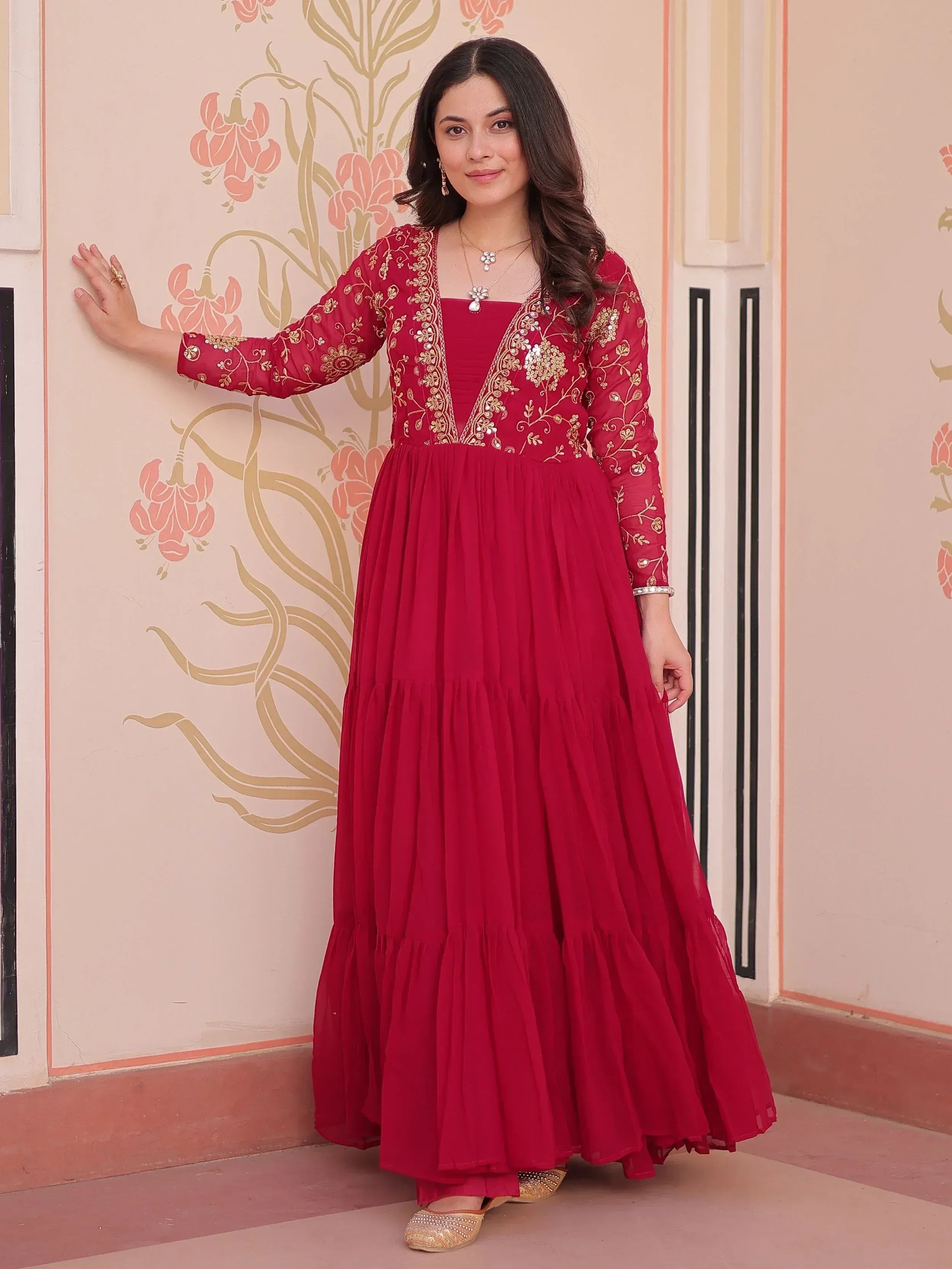 Red embroidered ethnic gown with gold detailing, perfect for festive occasions and weddings.