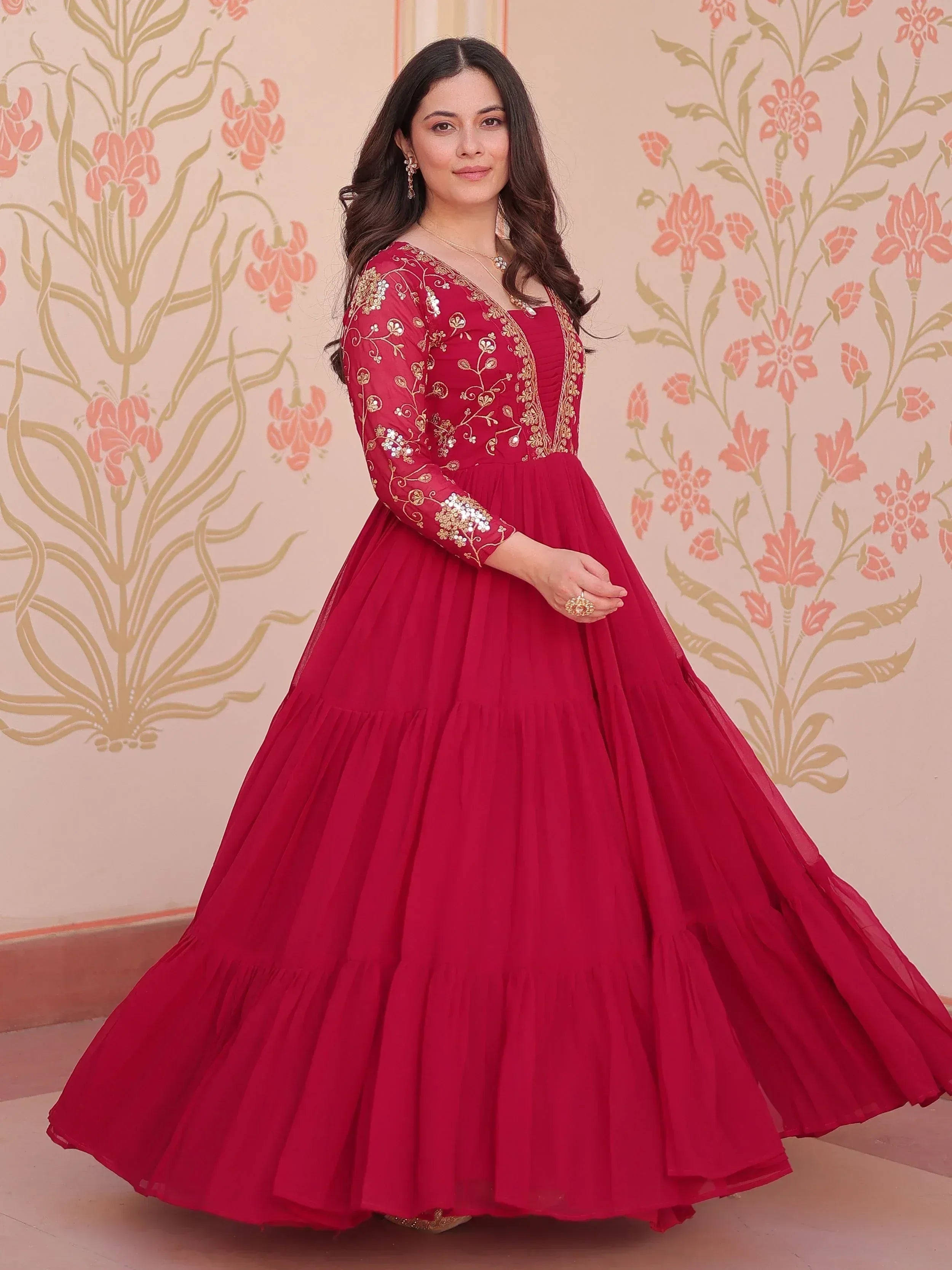 Red ethnic gown with gold embroidery, perfect for Indian celebrations and festive occasions.