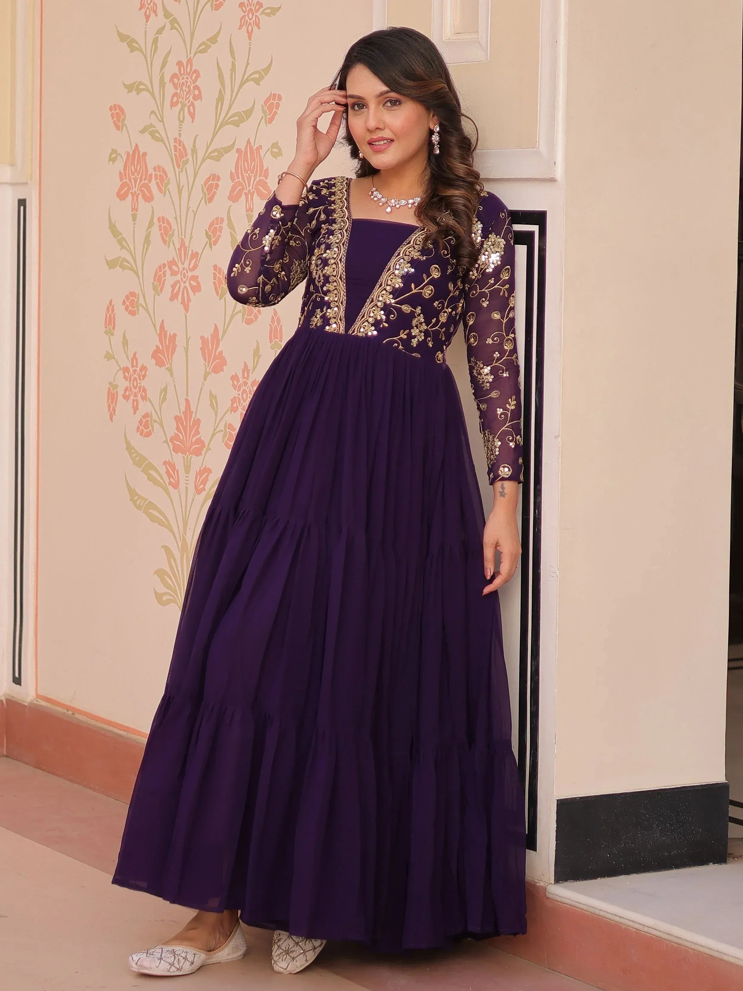 Elegant purple ethnic gown with gold embroidery, perfect for Indian celebrations and events.
