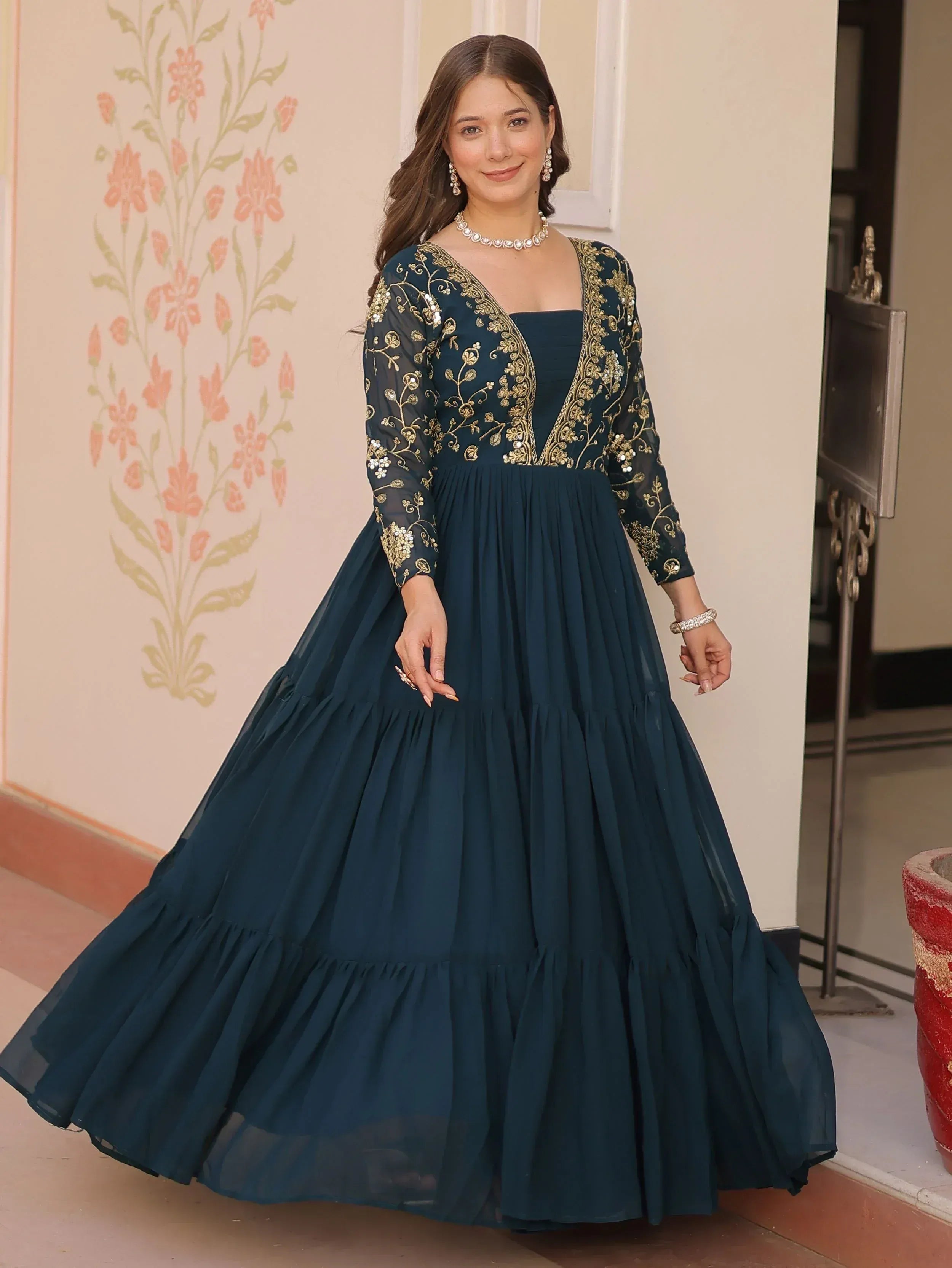 Elegant navy blue ethnic gown with gold embroidery, perfect for Indian celebrations and festive occasions.