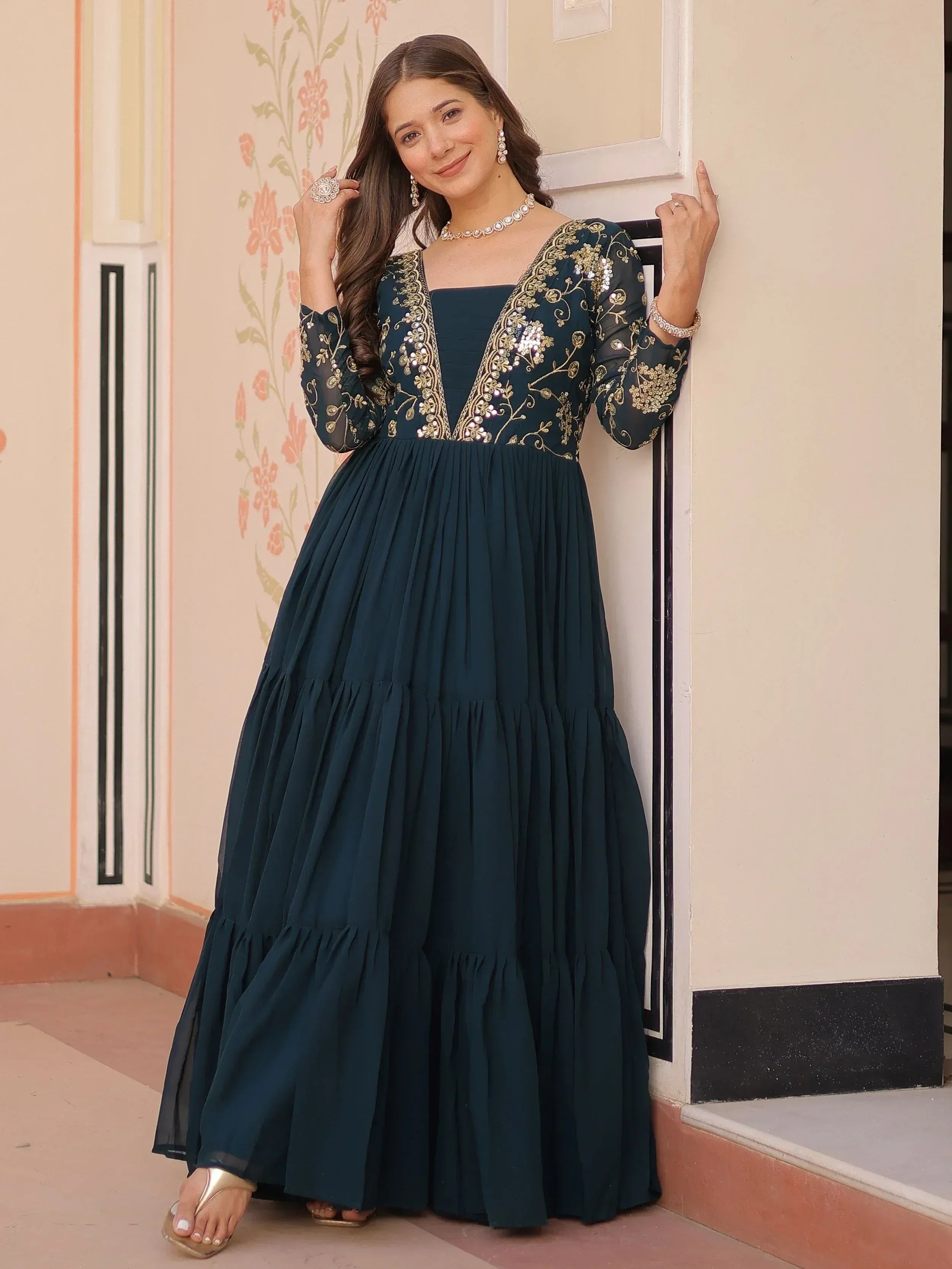 Elegant teal ethnic gown with gold embroidery and sequins, perfect for Indian occasions