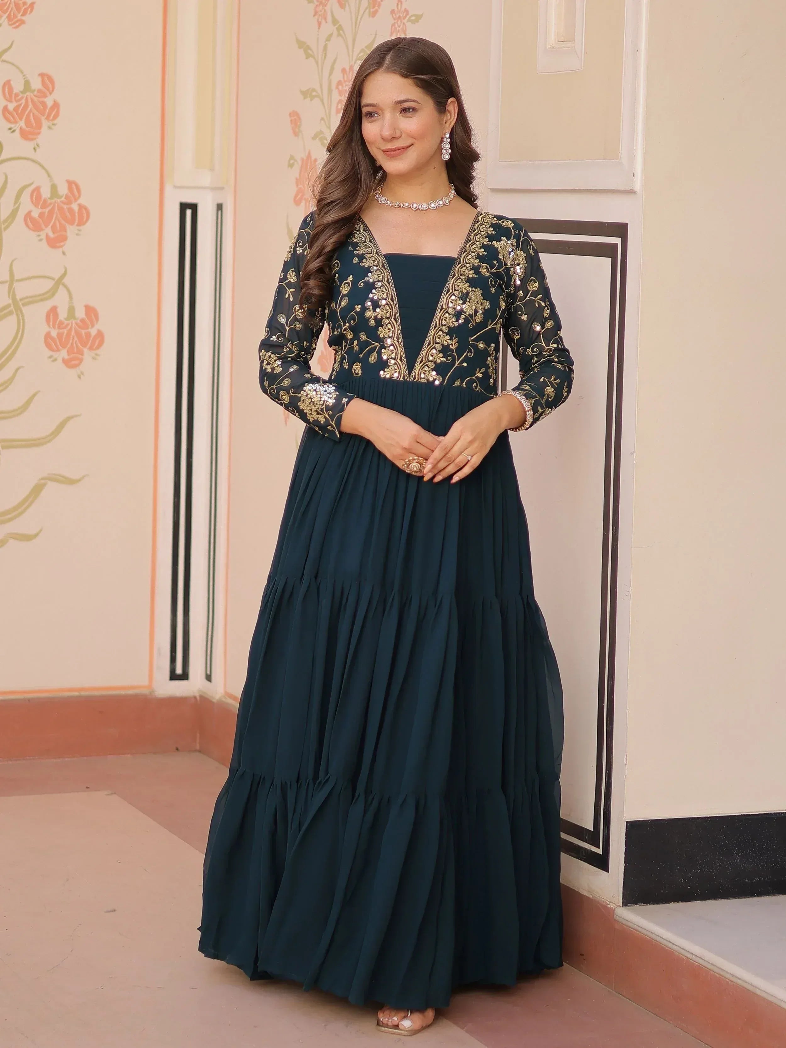 Elegant teal ethnic gown with gold embroidery, perfect for Indian festive occasions and weddings.