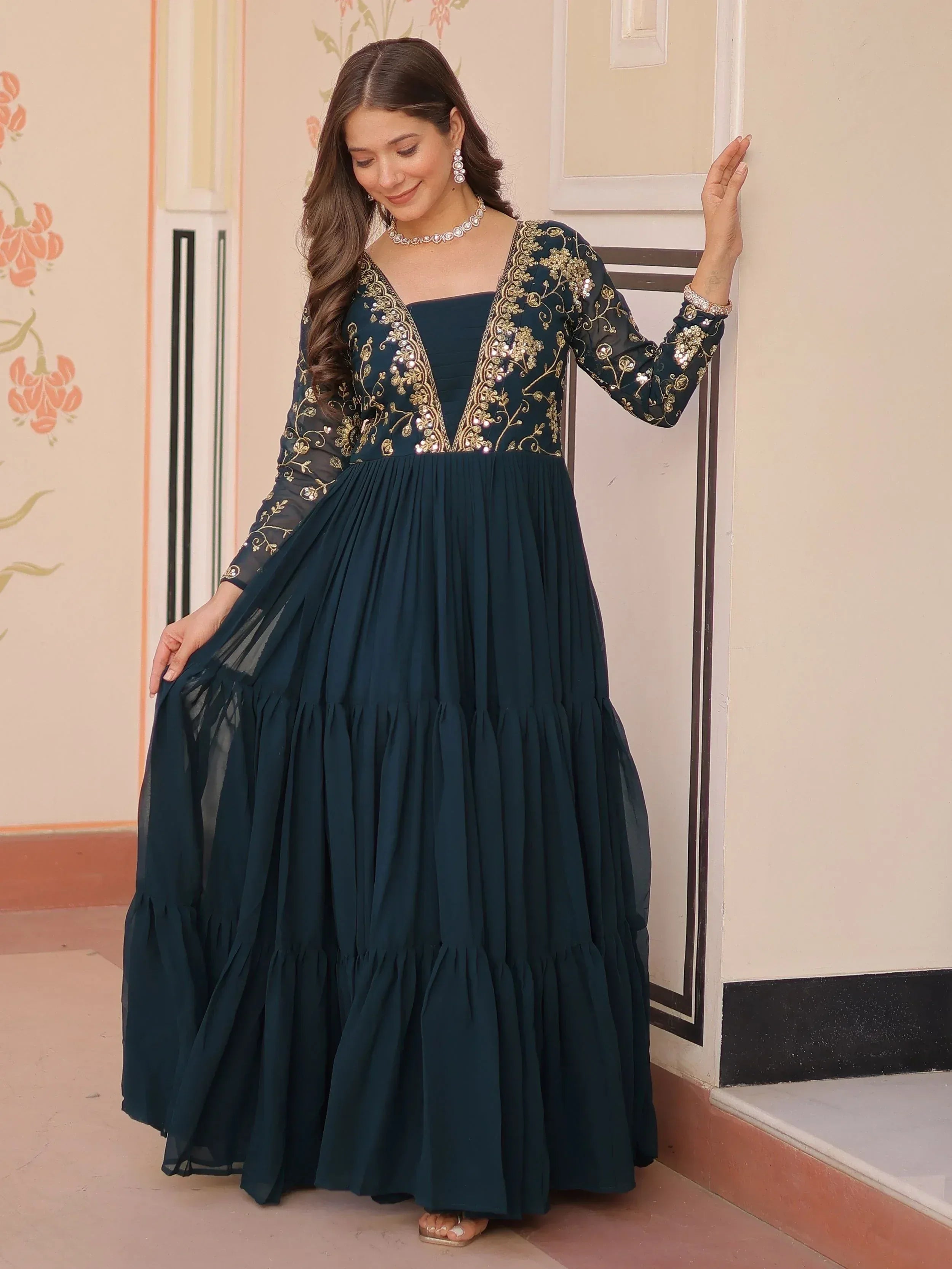Elegant navy blue ethnic gown with gold embroidery and sheer sleeves, perfect for Indian festive occasions