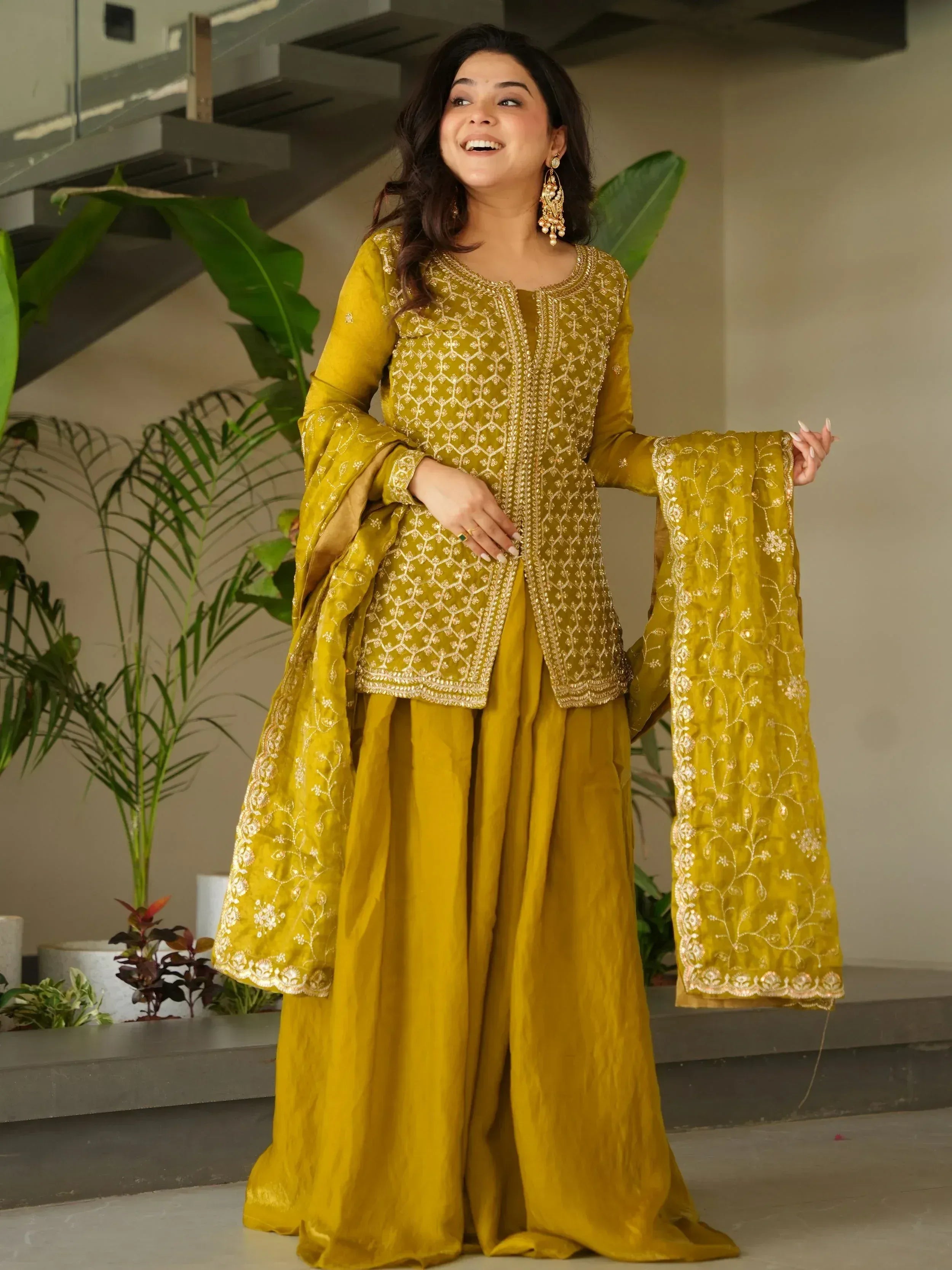 Mustard yellow embroidered salwar kameez with flared sleeves and gold detailing, perfect for ethnic occasions